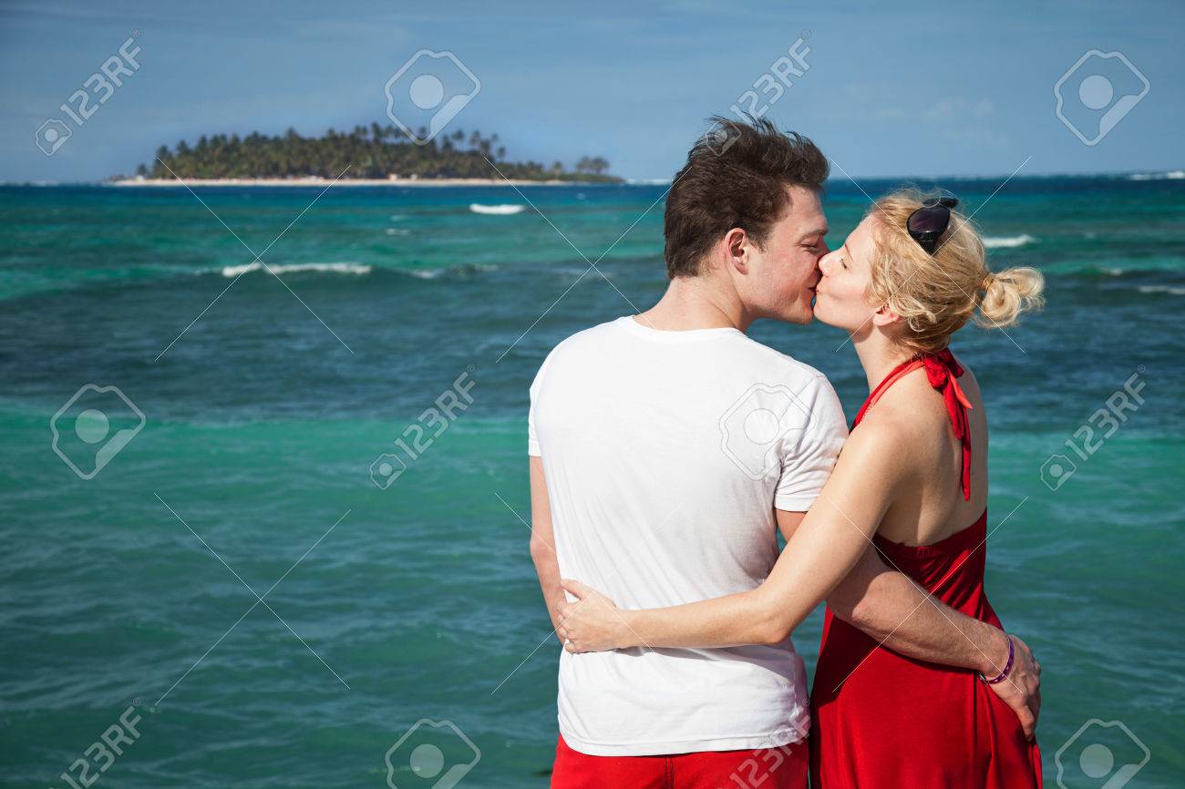 Romantic Couple Kissing At The Sean With Desert Island In