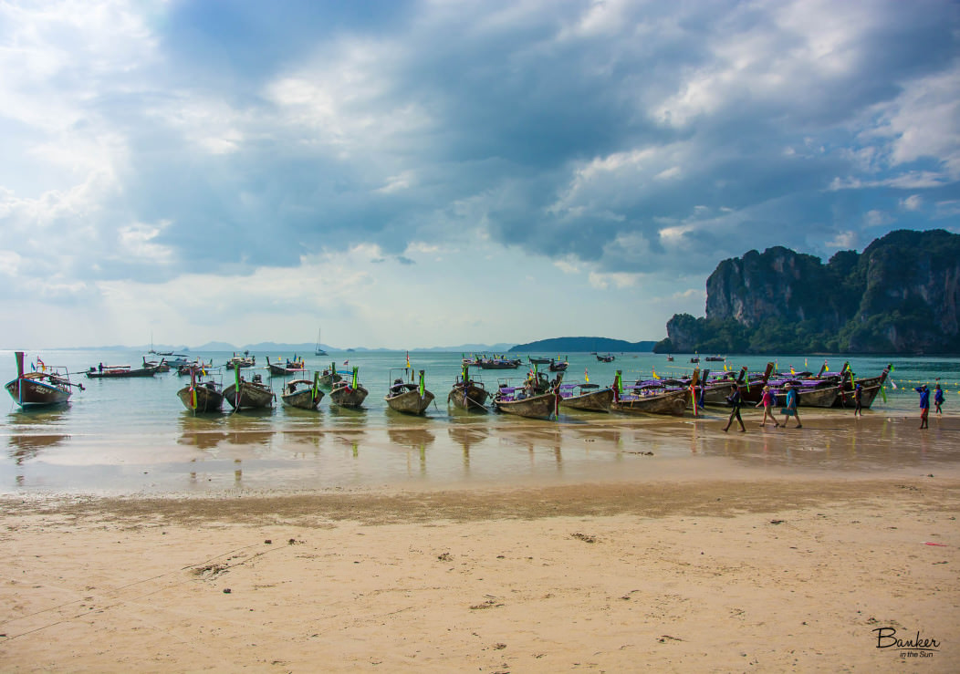 Row Of Long Tail Boats Parked On The Beach In West Railay Thailand