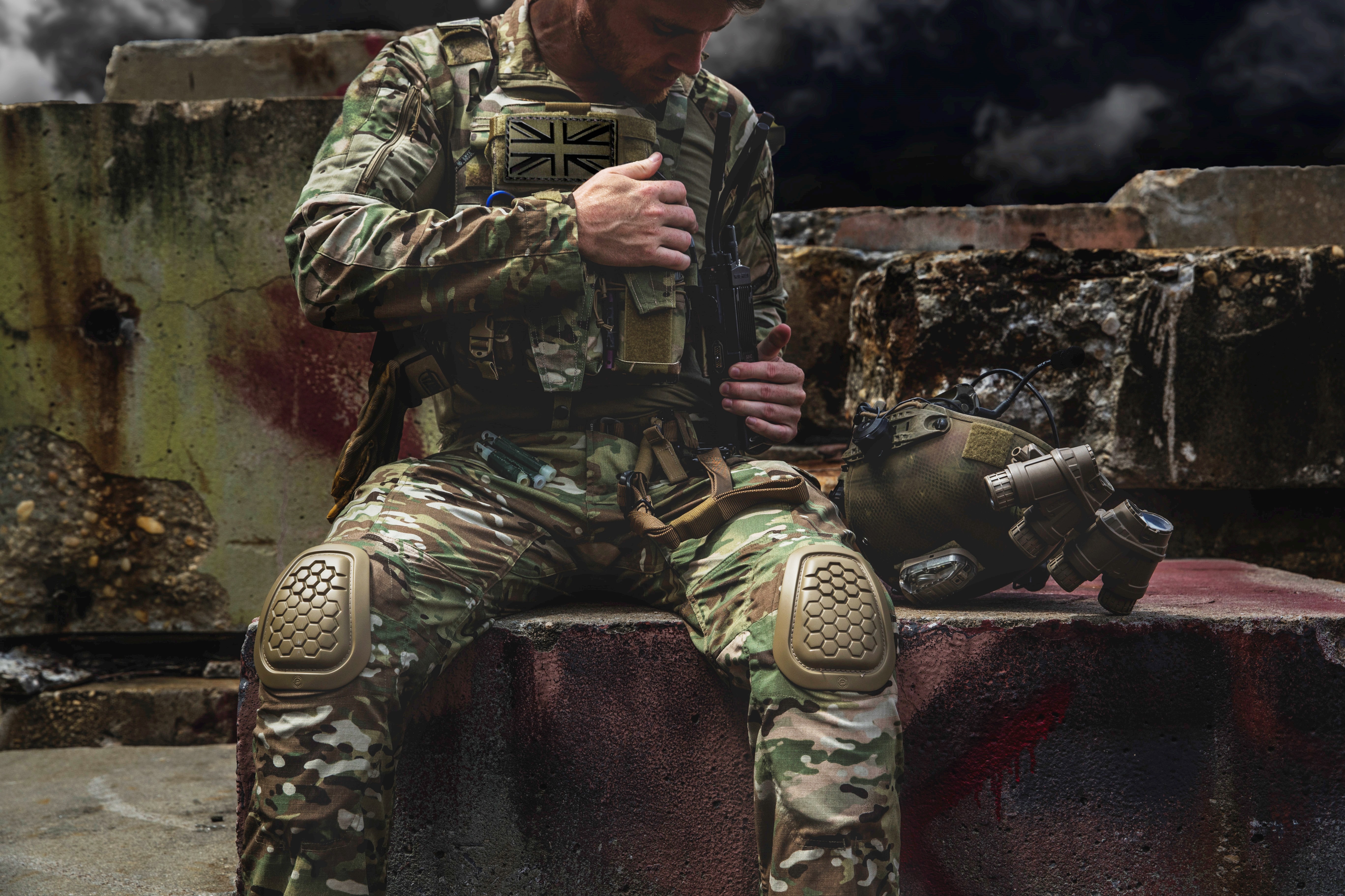 A British Commando Marine adjusts his gear in a war-torn urban setting