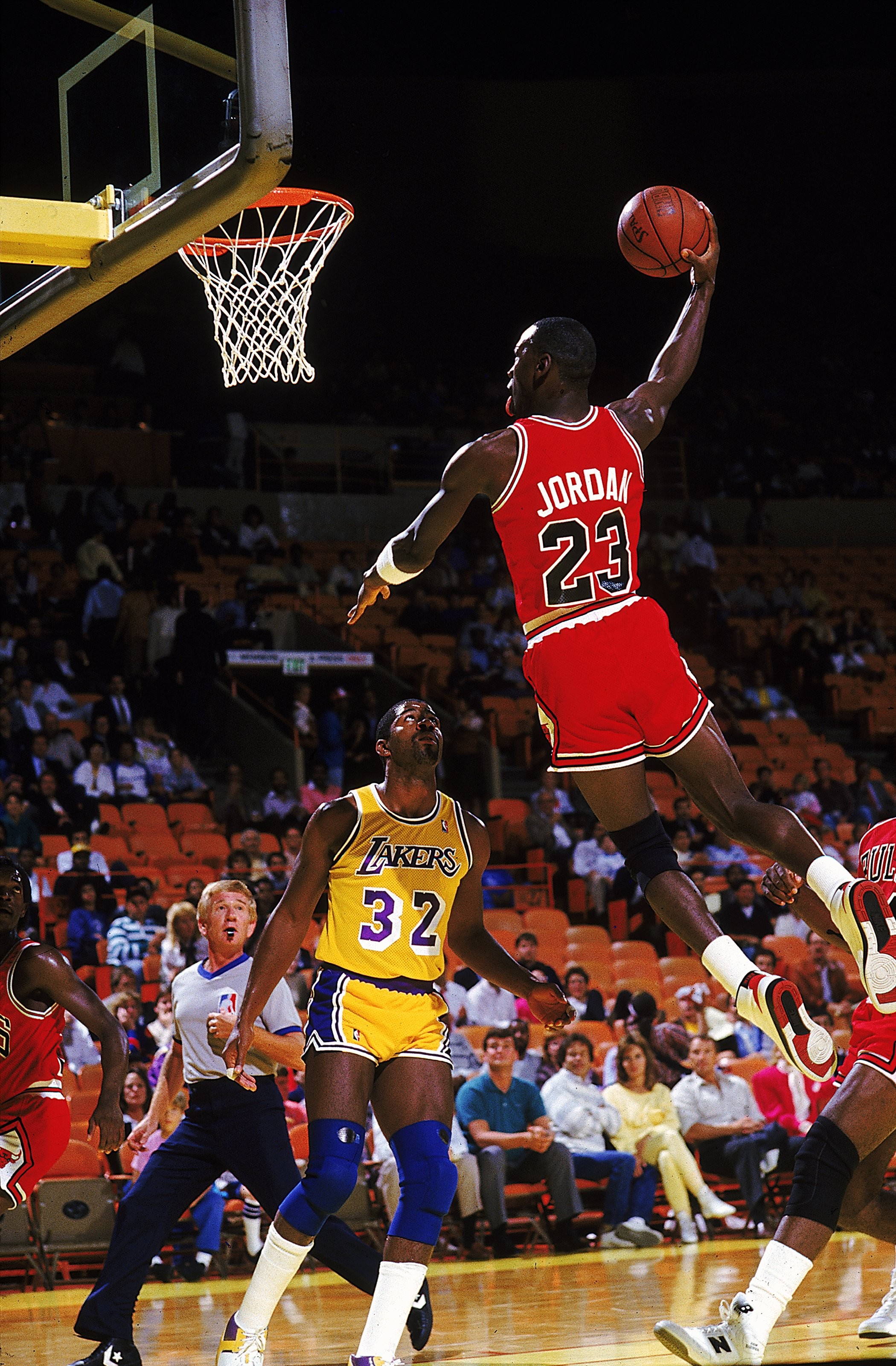 Michael Jordan performing a dunk in a basketball game against the Lakers