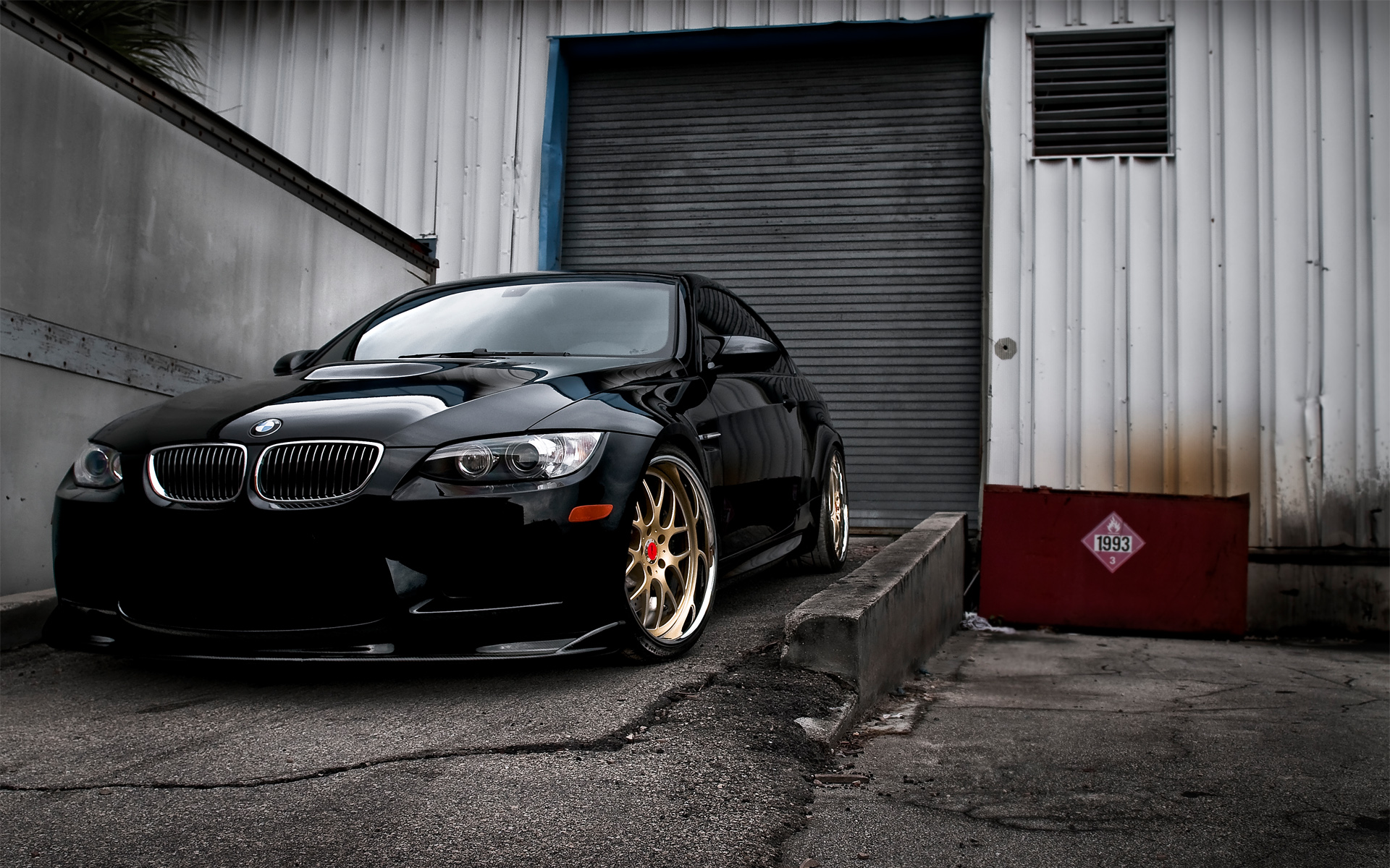 Sleek Black BMW M3 Parked in Industrial Setting