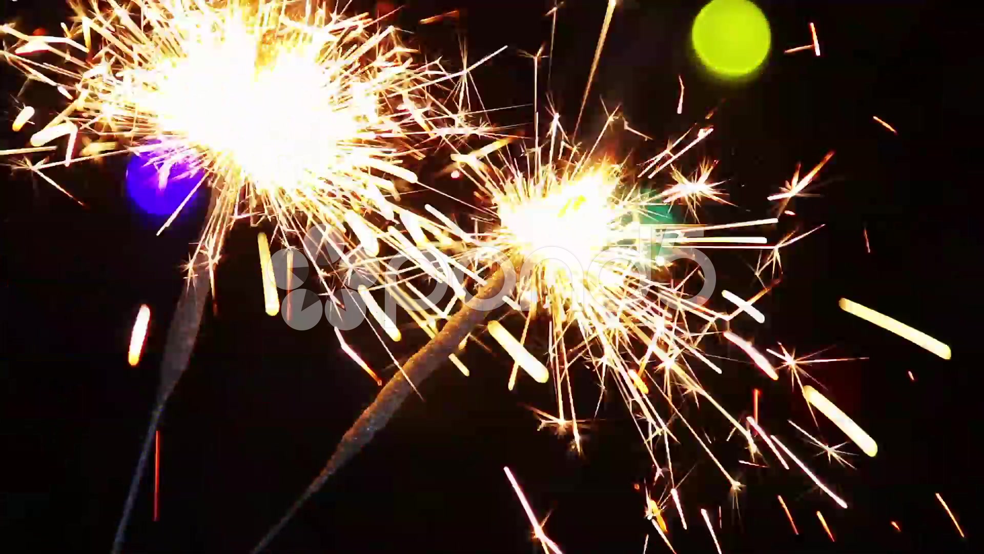 Burning Sparklers On The Background Of Christmas Illuminations