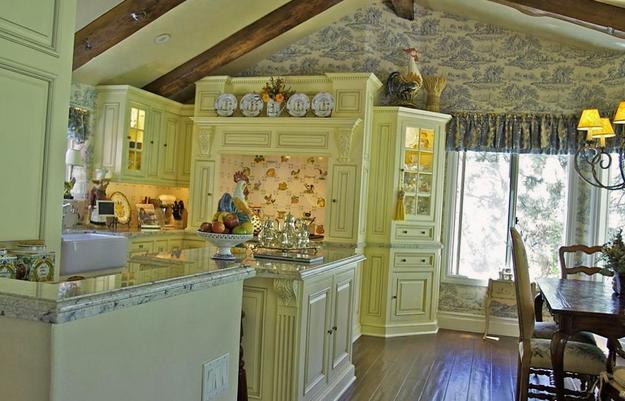 The idea of kitchen country style in yellow tones with Wallpaper on the  walls