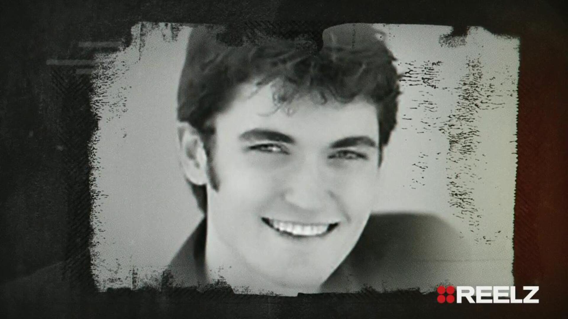 Black and white portrait of a young man smiling