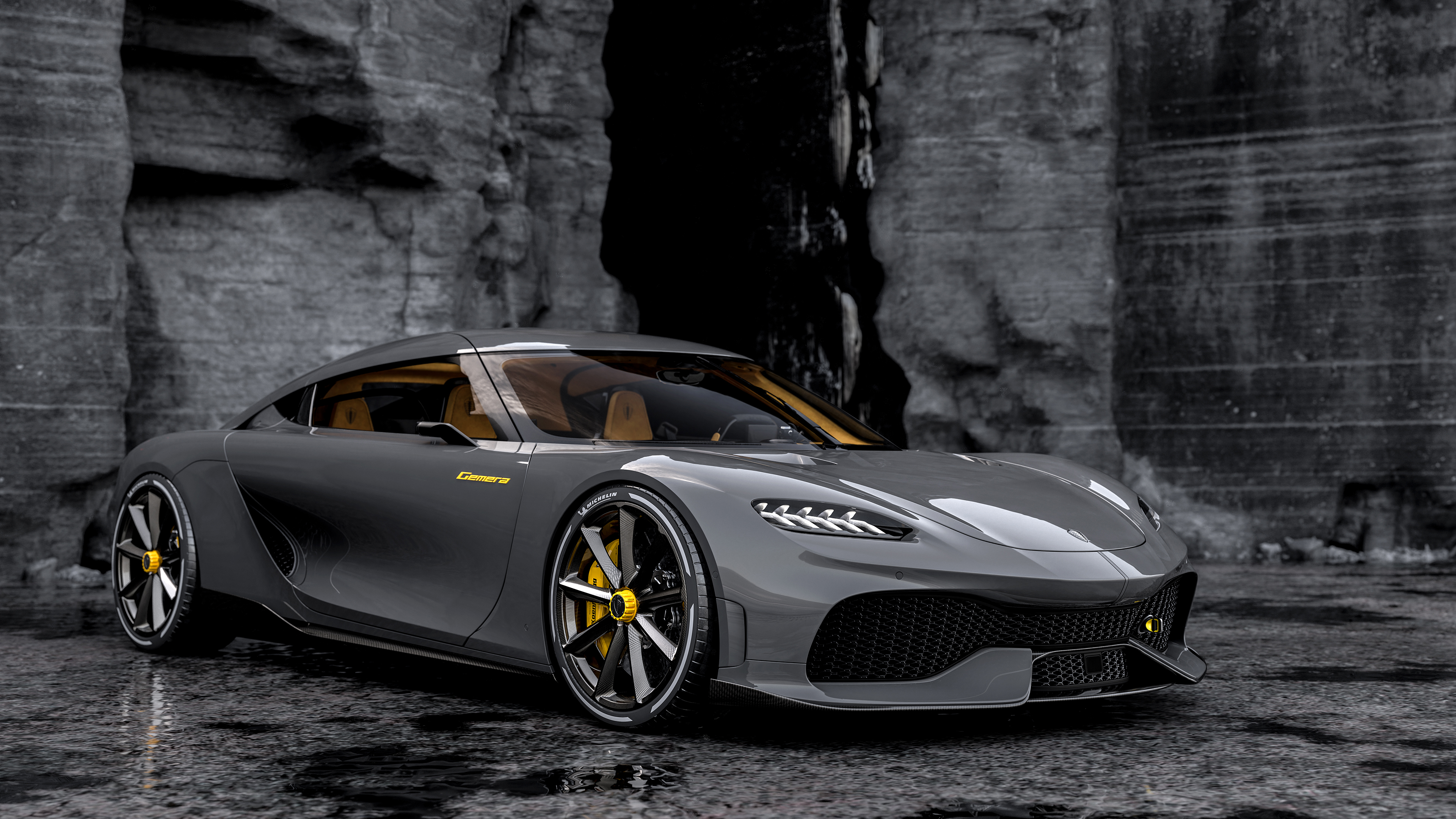 Sleek black Koenigsegg sports car parked against a dramatic rock backdrop