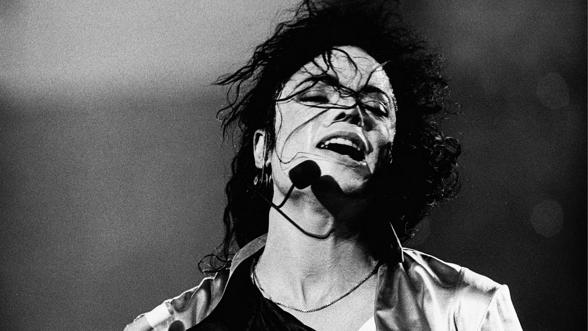 Black and white photo of Michael Jackson performing on stage