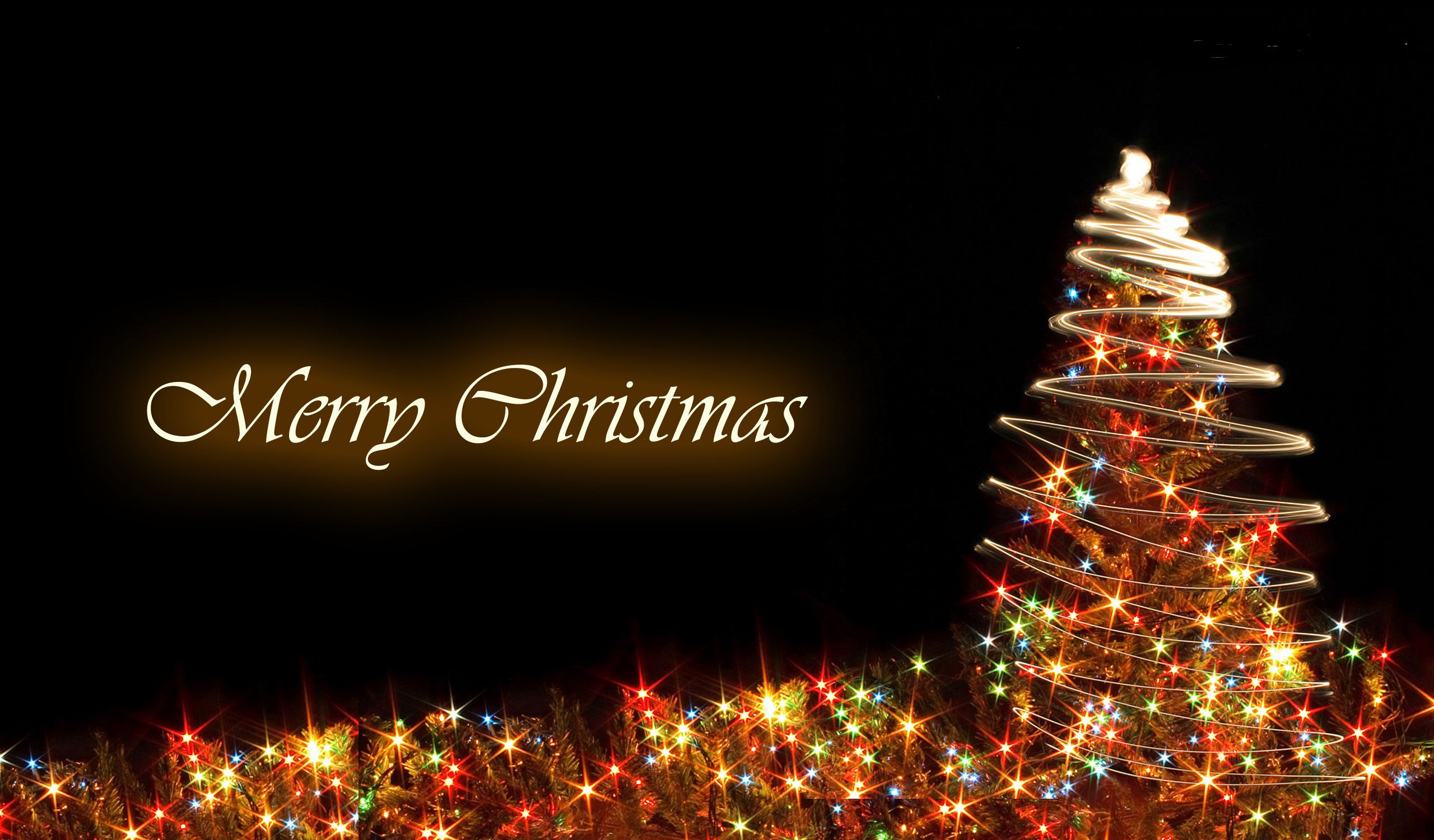 A Christmas tree adorned with colorful lights, set against a black backdrop with the message 