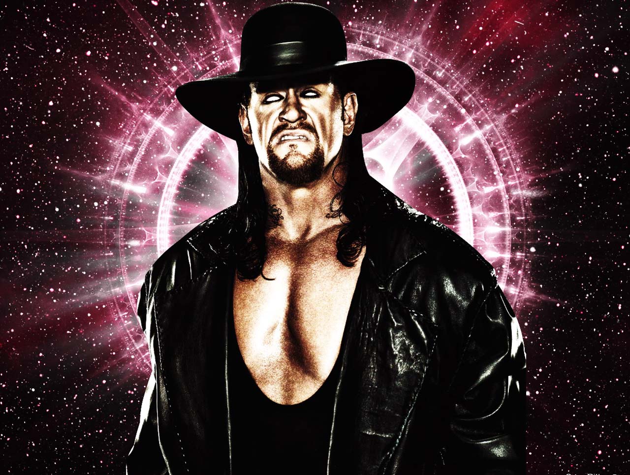 The Undertaker Rolls His Eyes Back As He Poses On One Knee Raw