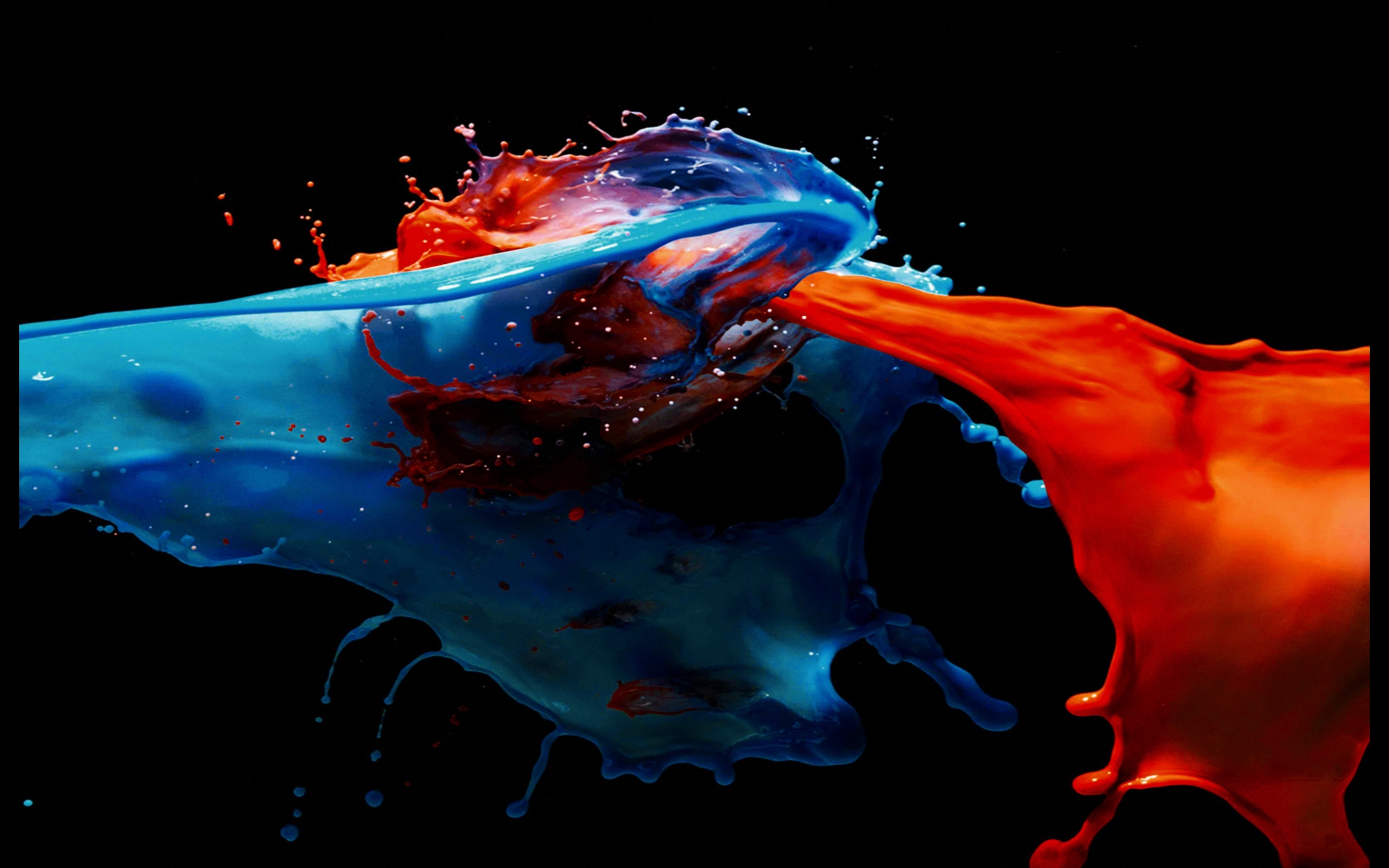 Dynamic splash of blue and orange paint on a black background