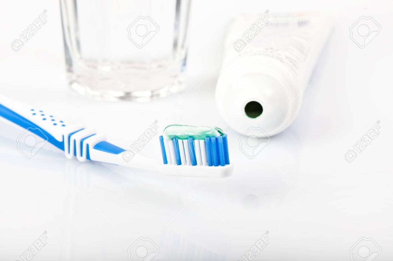 Toiletries On White Background Toothpaste Toothbrush Glass