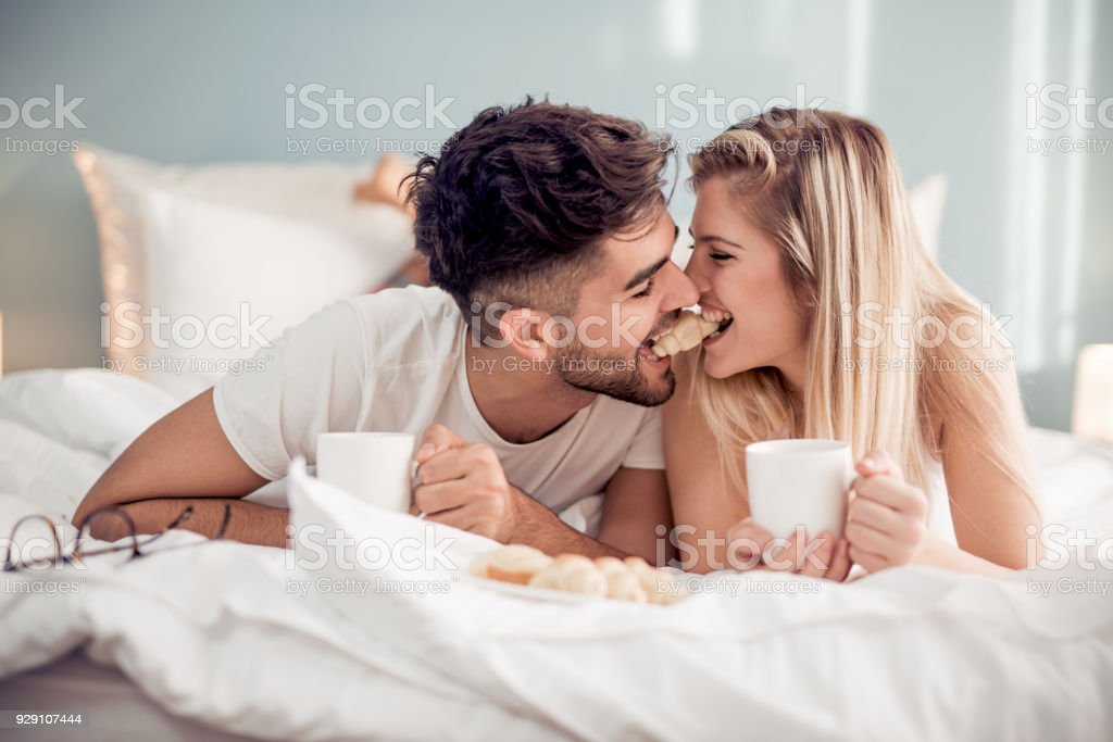 Sweet Young Couple Lying In The Bed In Bedroom Stock Photo
