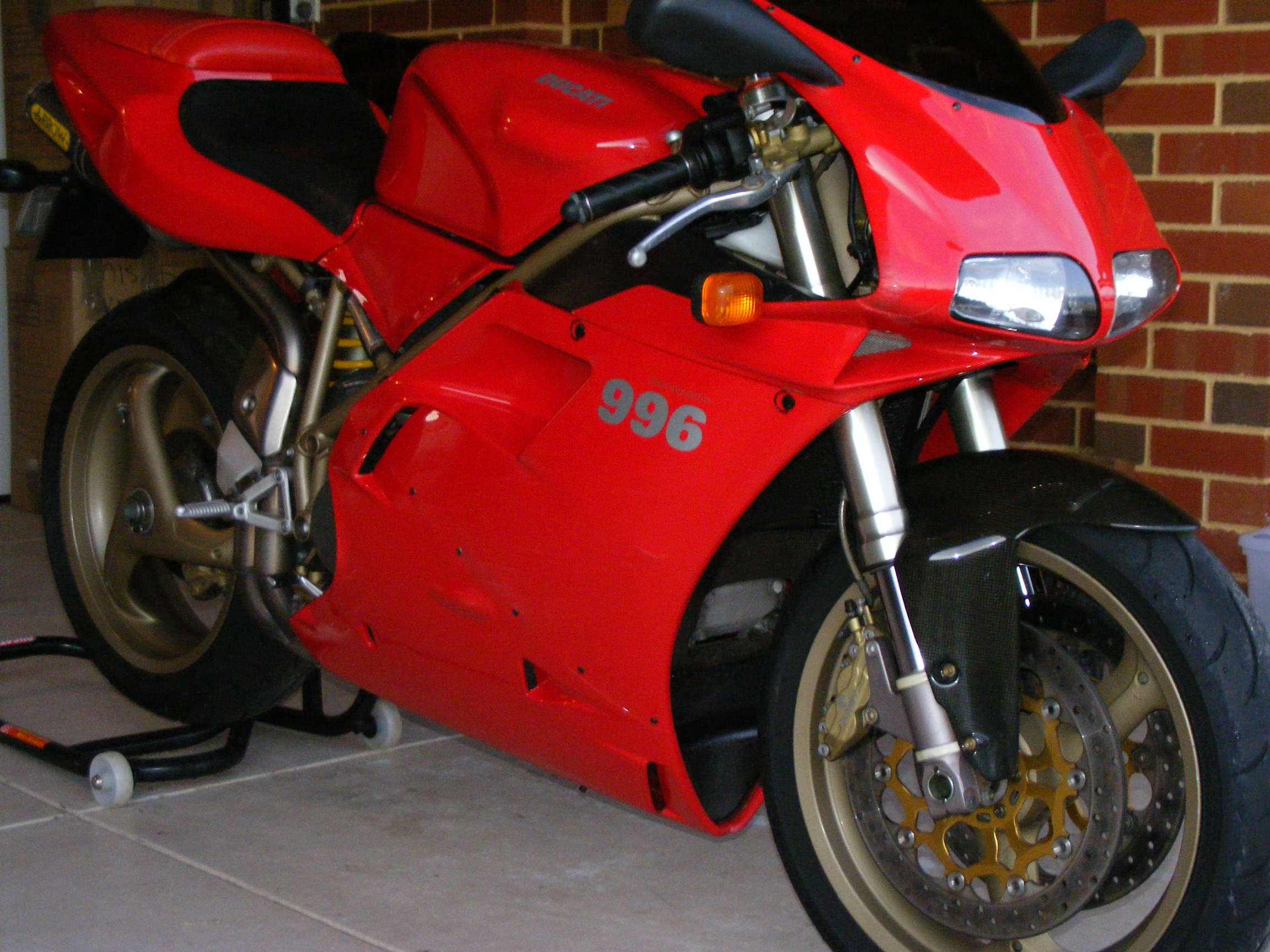 Red Ducati 996 parked in a garage