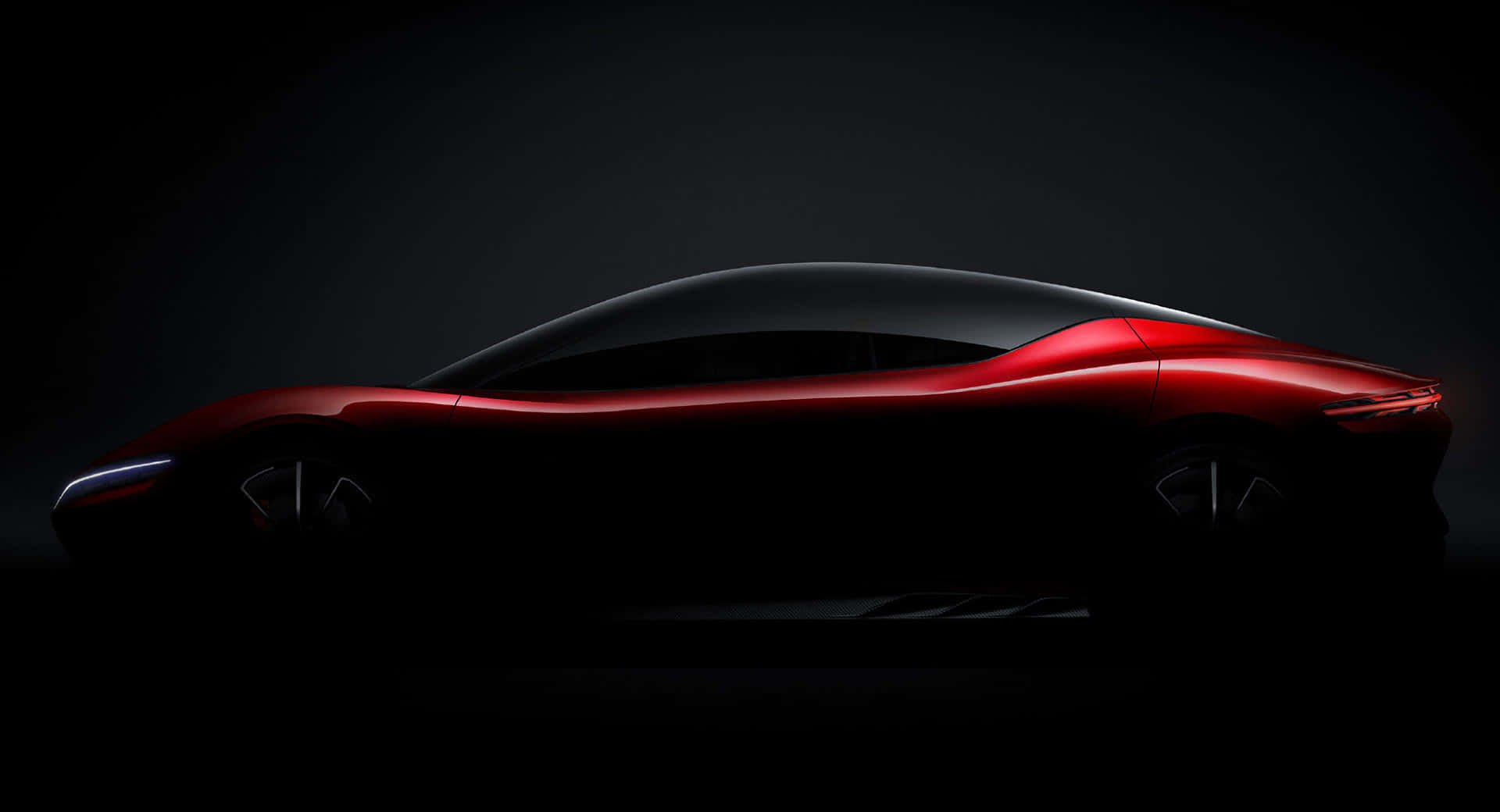 A shadowy silhouette of the BYD Shark, a sleek and futuristic concept car, hinting at its dynamic design and innovative features