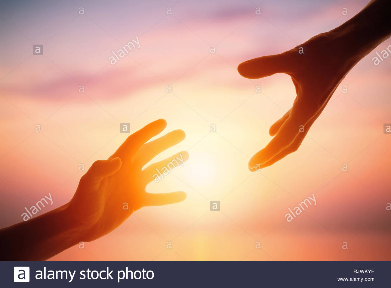 Giving A Helping Hand On The Background Of Dawn Stock Photo