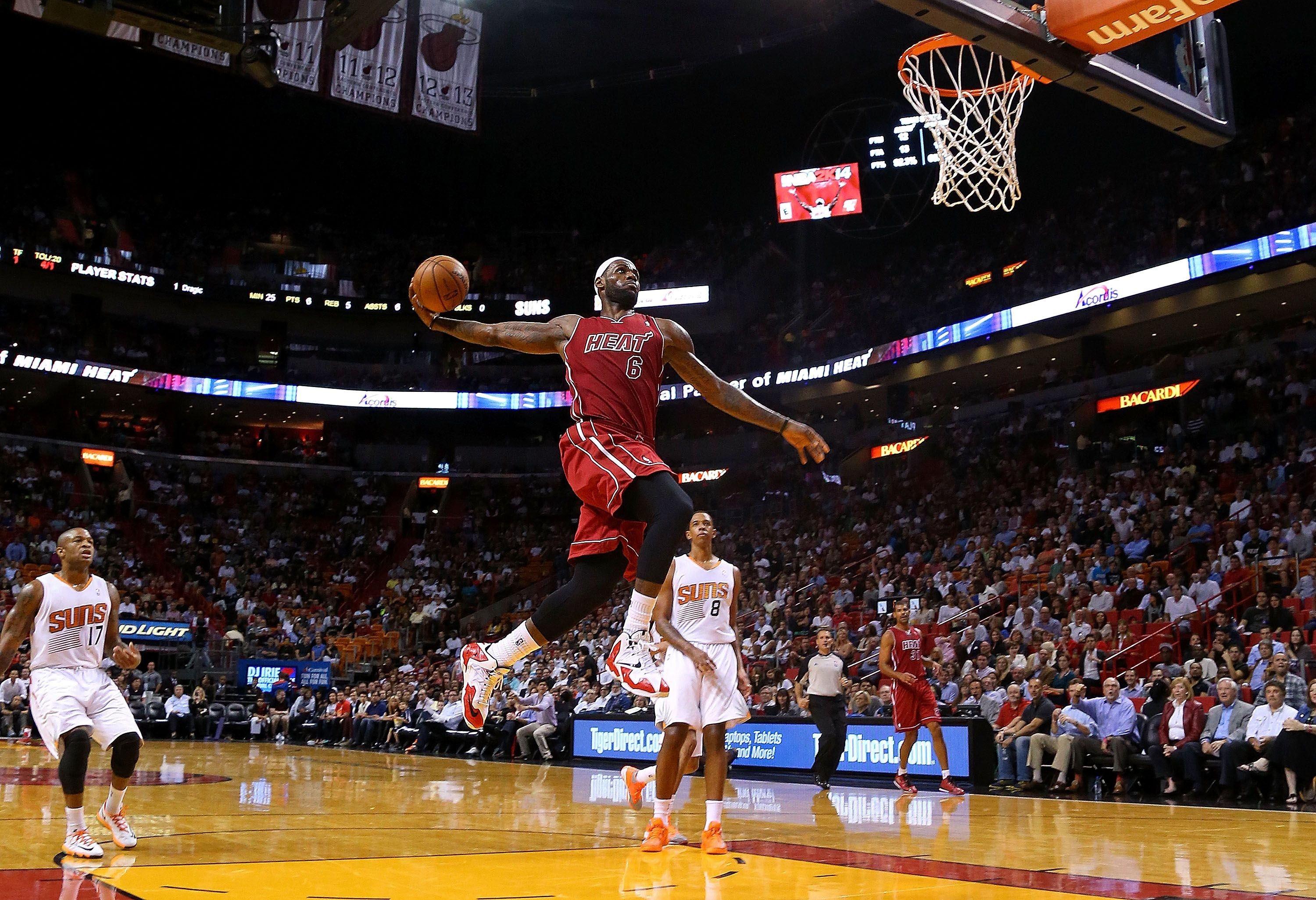 LeBron James performing a powerful dunk during an NBA game against the Phoenix Suns