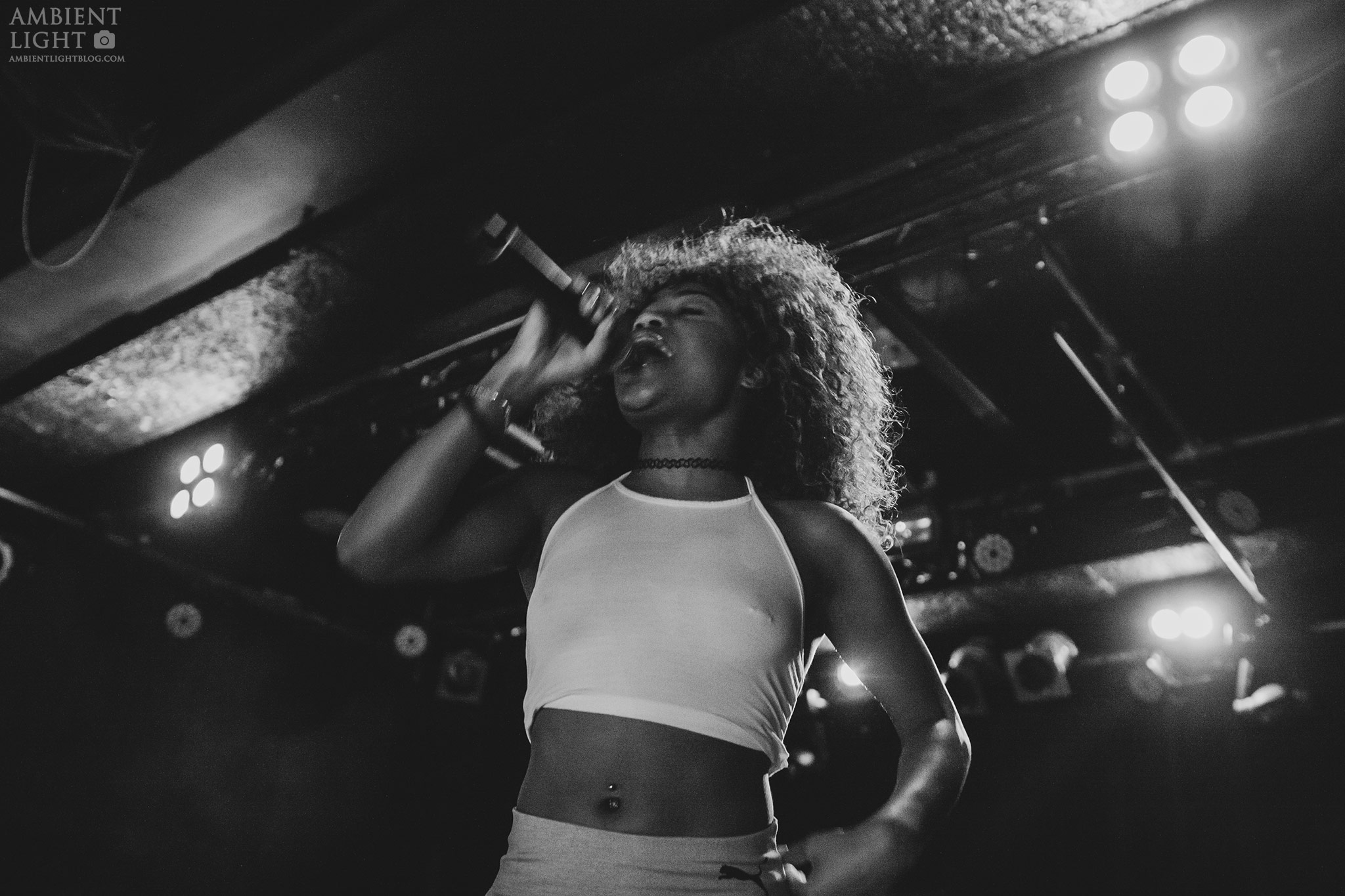 Bhad Bhabie performing live on stage, passionately singing into a microphone