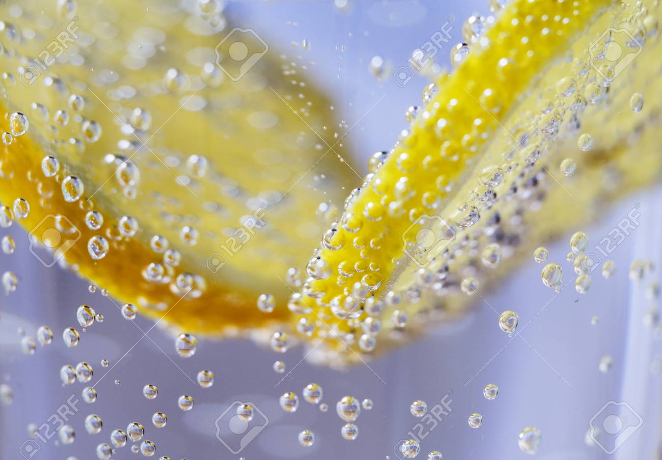 Lemon Slices In Clear Soda Water Bubble Background Macro Stock