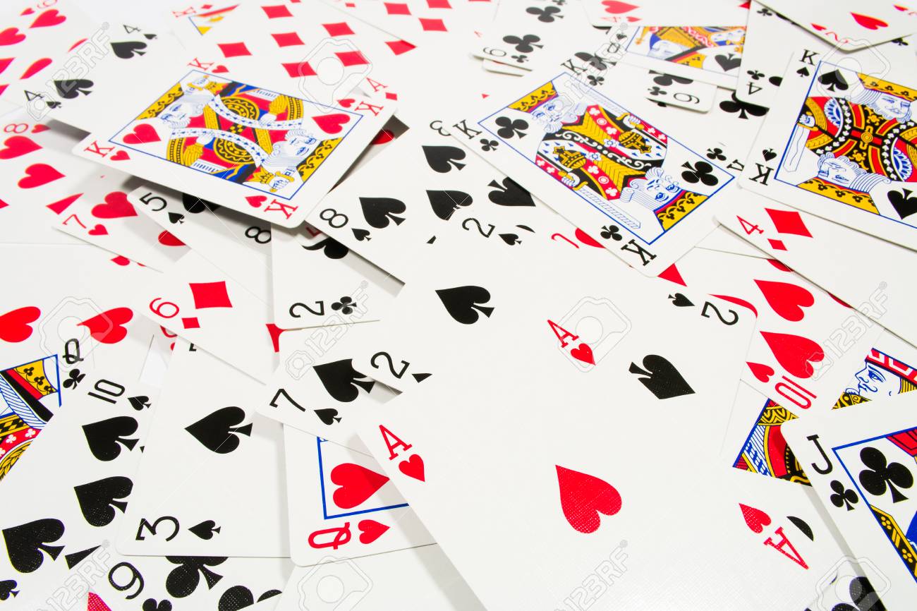Playing Cards Scattered On The Table Background Stock Photo