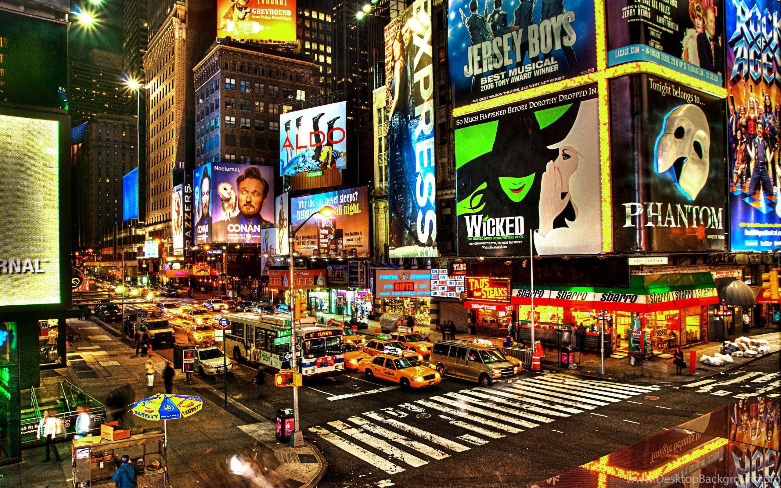 A vibrant night scene of New York City's Times Square, showcasing Broadway show advertisements