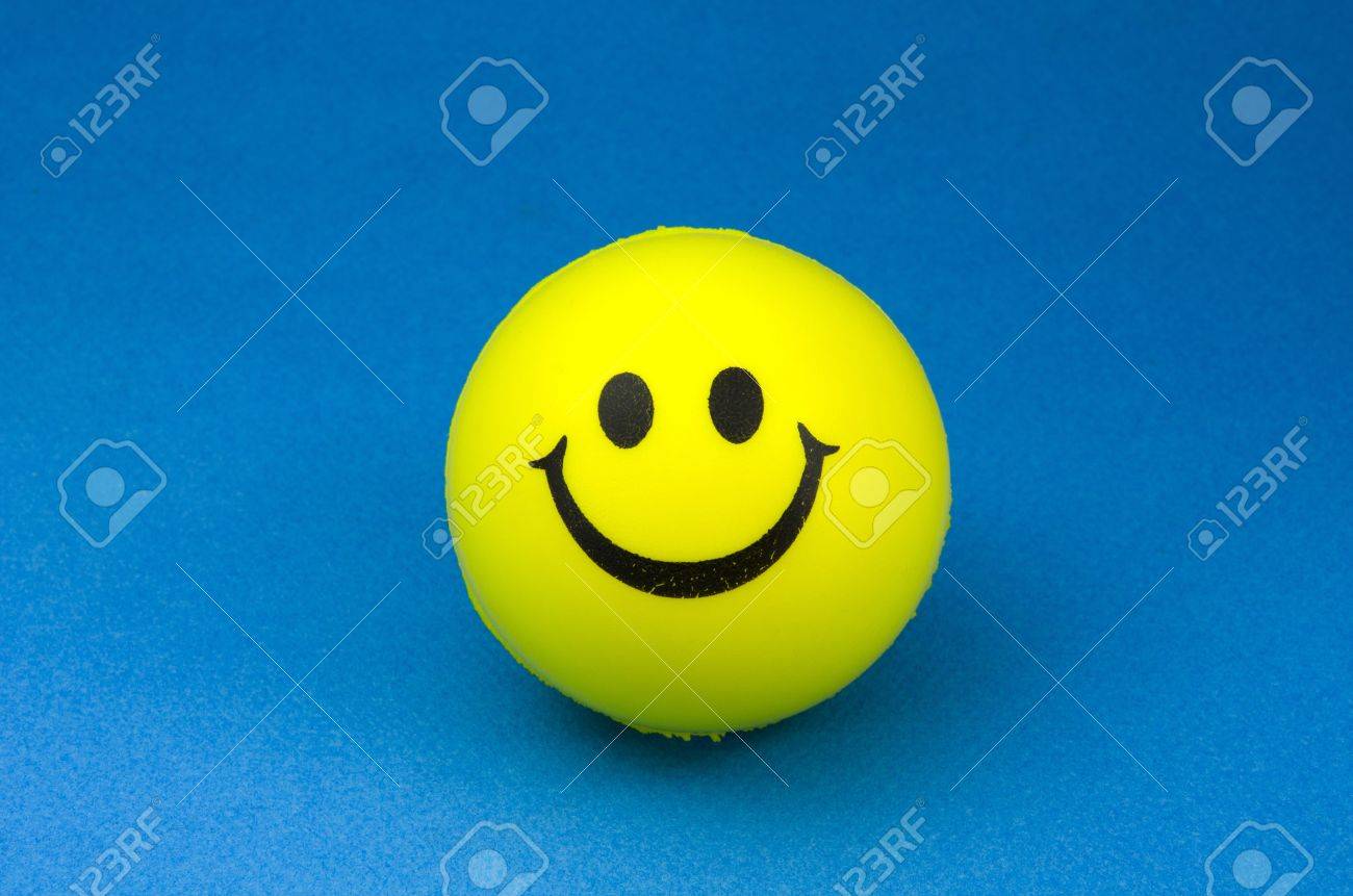 Yellow Smiley Face On Blue Background Stock Photo Picture And