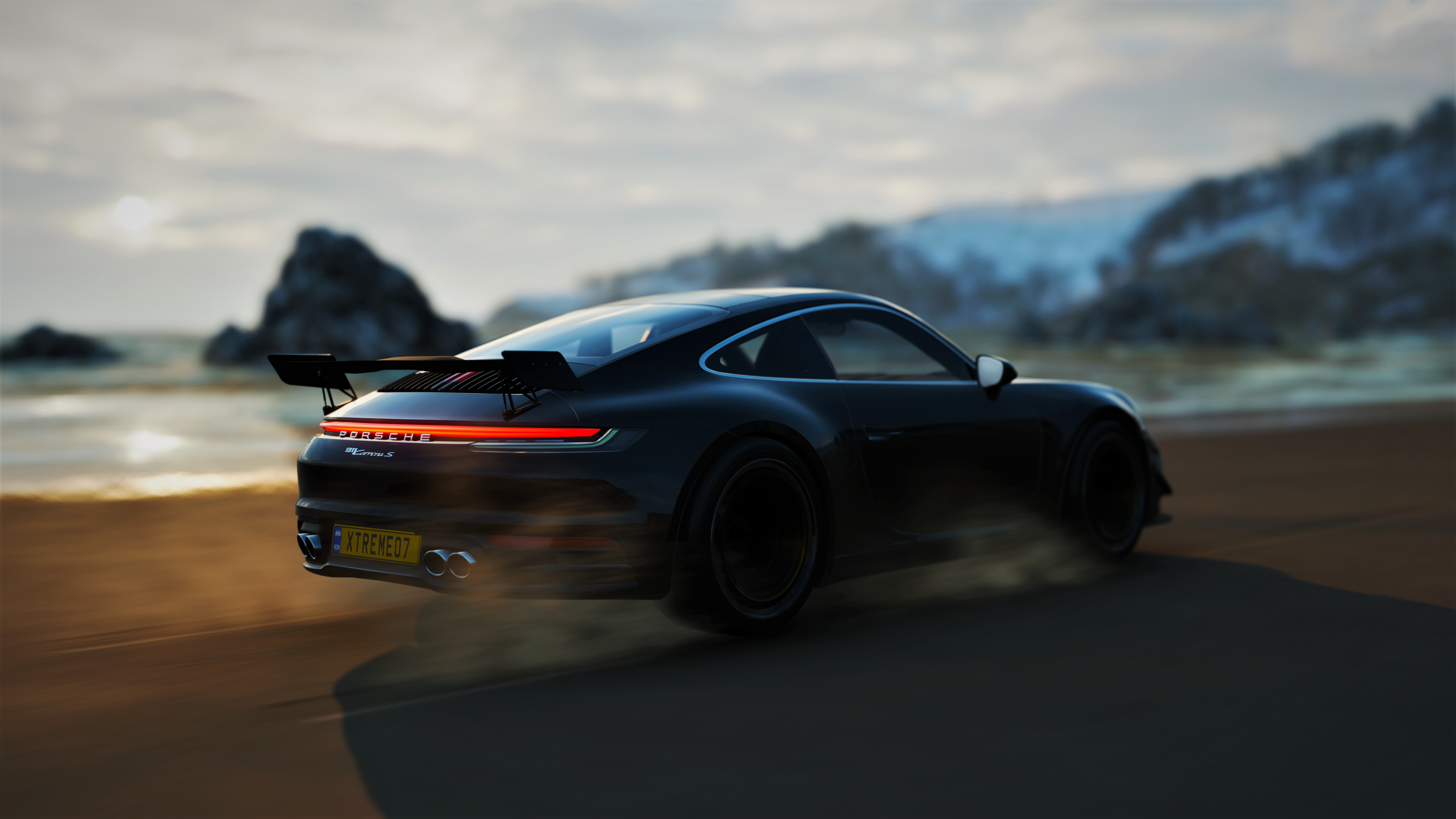 A sleek black Porsche 911 sports car speeding along a sandy beach at sunset, kicking up dust and sand in its wake