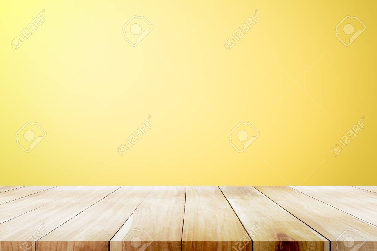 Empty Wooden Deck Table Over Yellow Wallpaper Background For