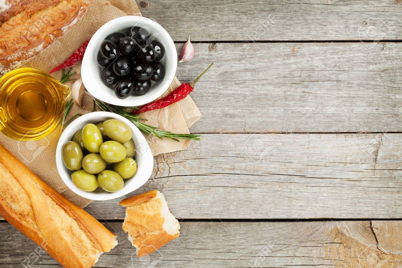 Italian Food Appetizer Of Olives Bread And Spices On Wooden