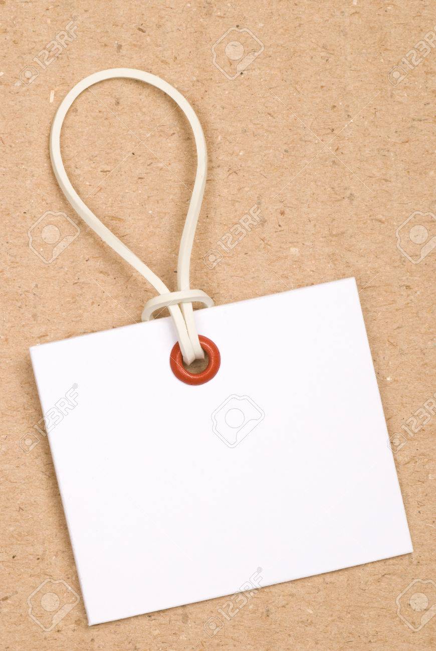 White Tag With Rubber Band Red Eyelet Card Board Background
