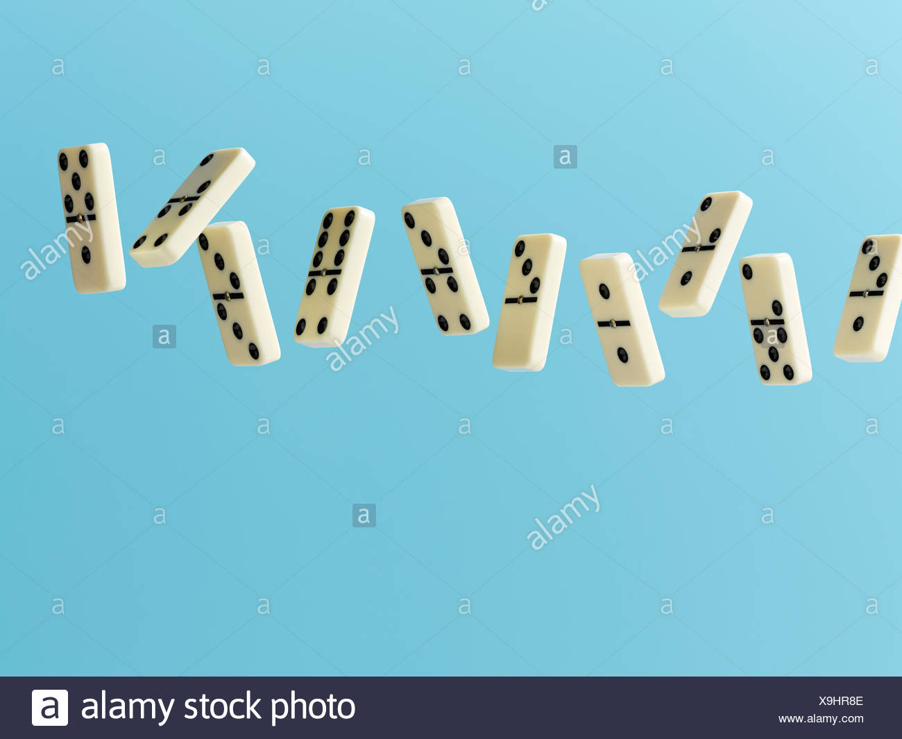 Floating dominos on blue background Stock Photo 281289246