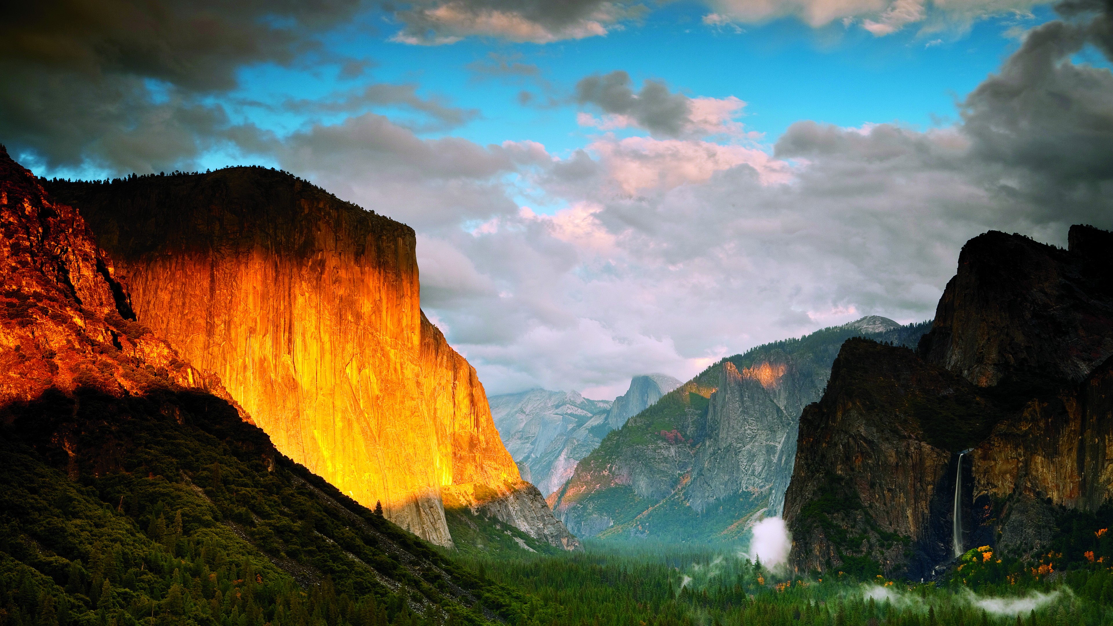 4K HD wallpaper of Yosemite Valley at sunset with El Capitan glowing orange and Yosemite Falls in the distance