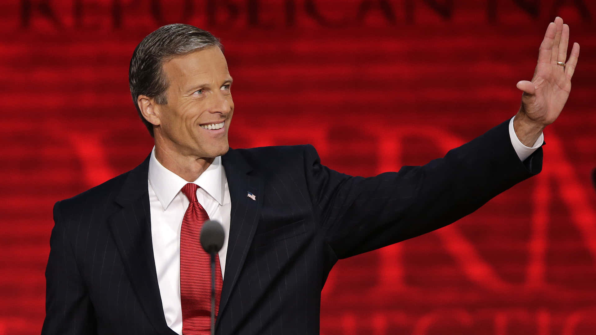 Senator John Thune Posed Against A Red Wallpaper