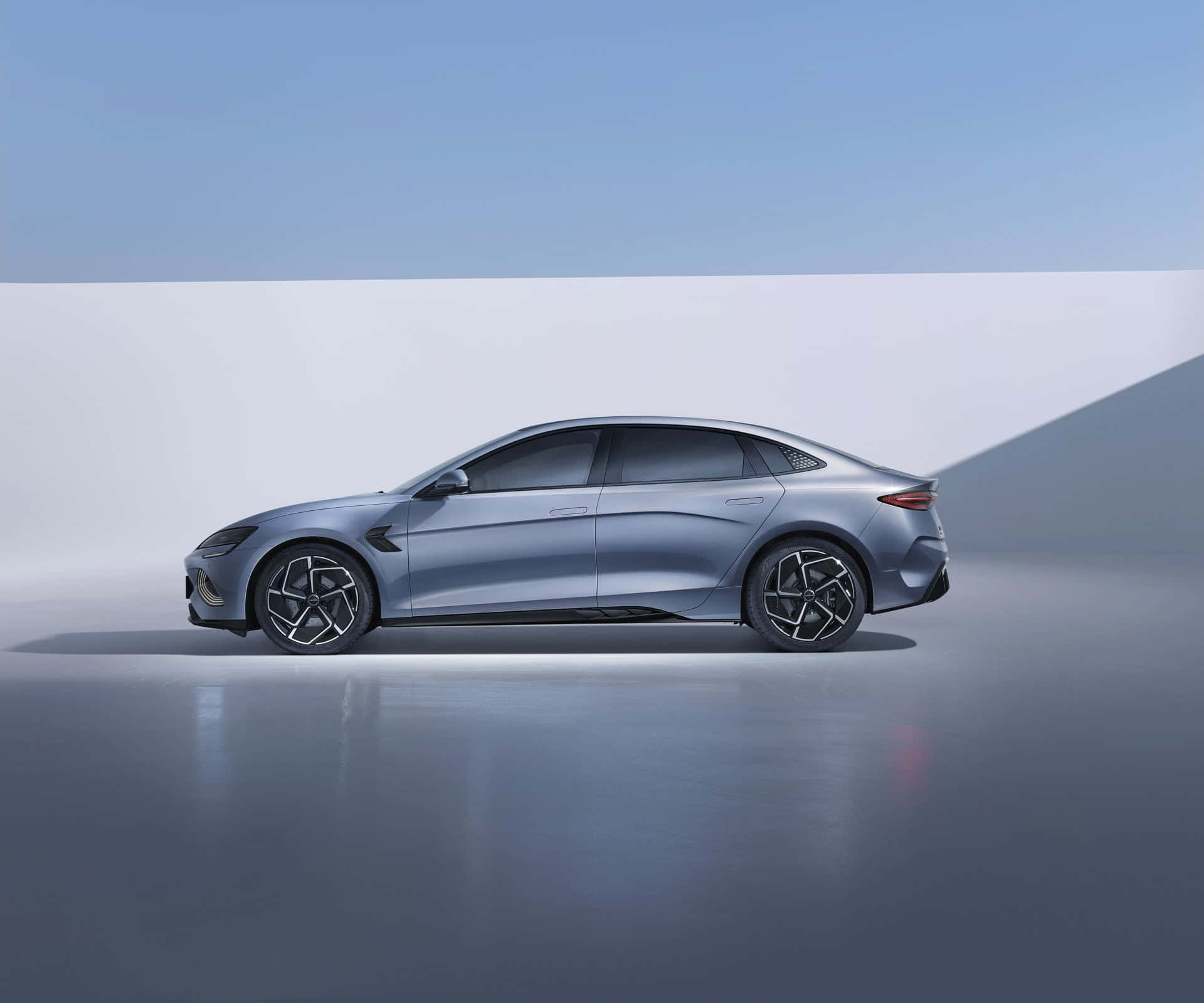 Sleek and futuristic BYD Shark electric sedan in a minimalist studio setting