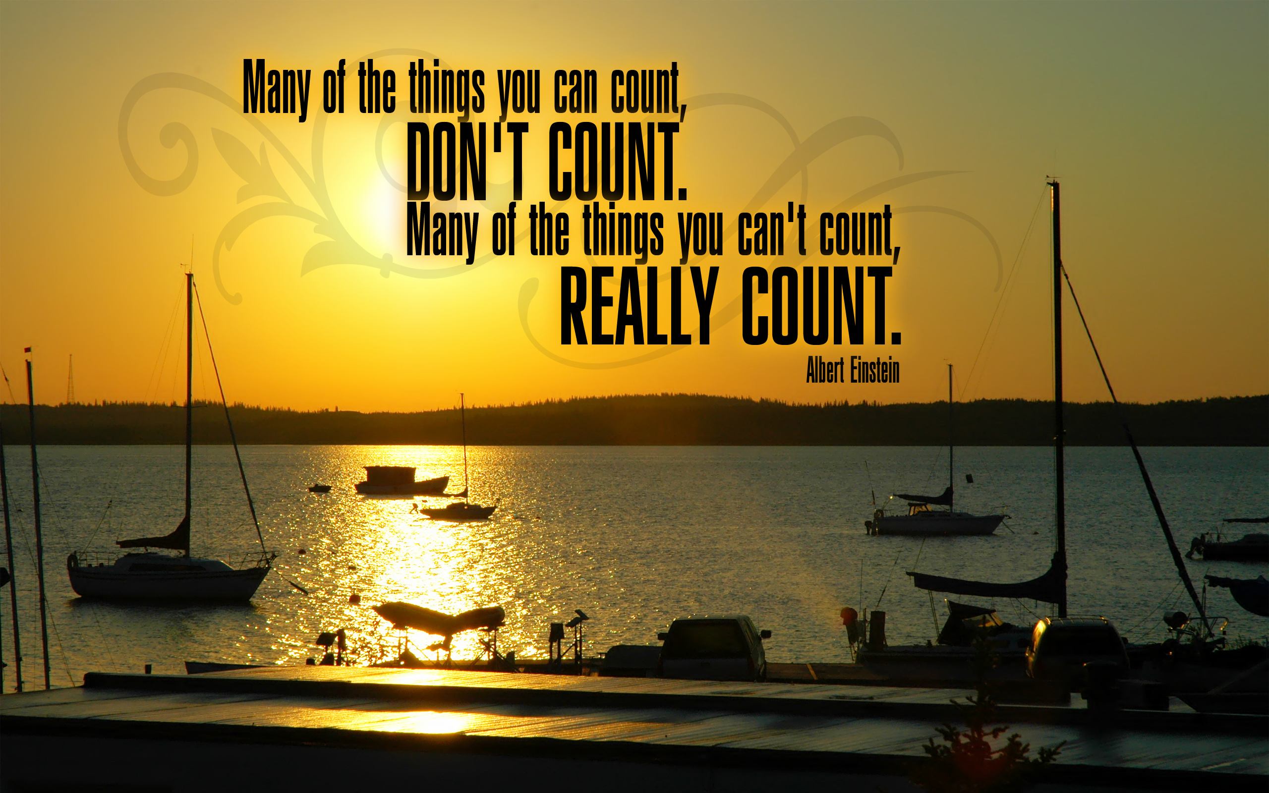 Motivational quote by Albert Einstein on a beautiful sunset background. Text reads: 