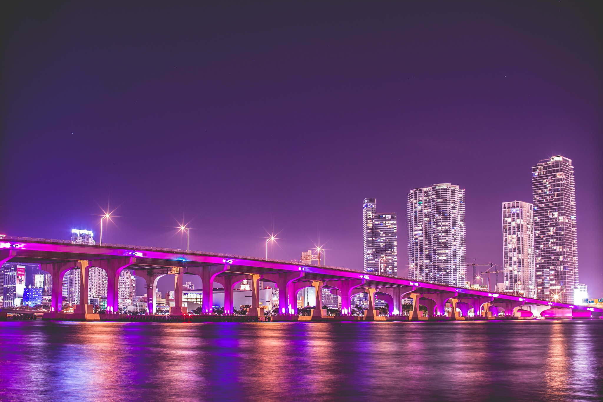 Vivid night view of Miami skyline and illuminated bridge