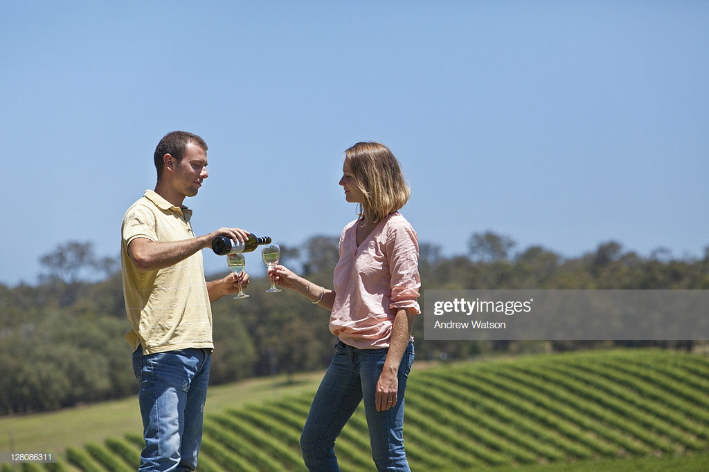 Couple Drinking Wine With Vineyard In The Background Montgomerys