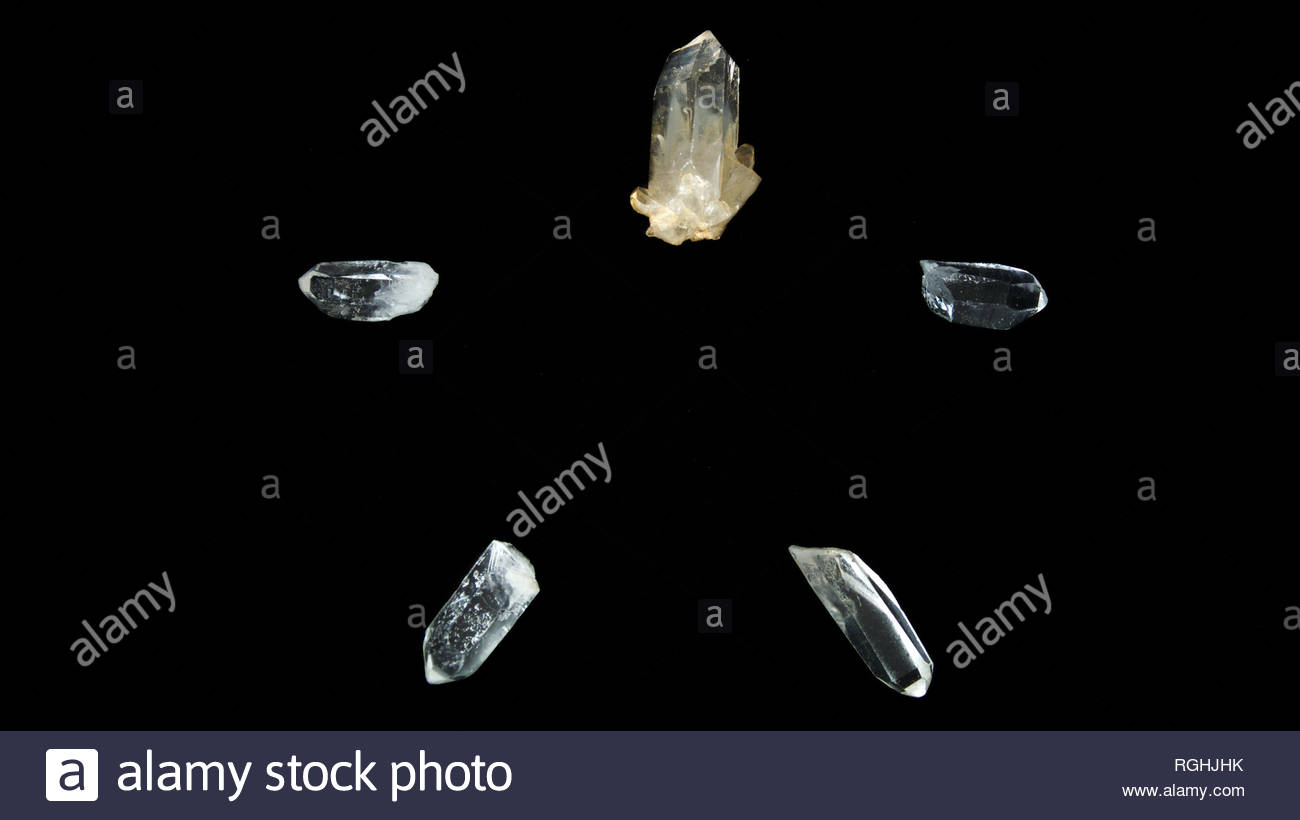 Five Clear Quartz Crystal Points On Black Background Forming A