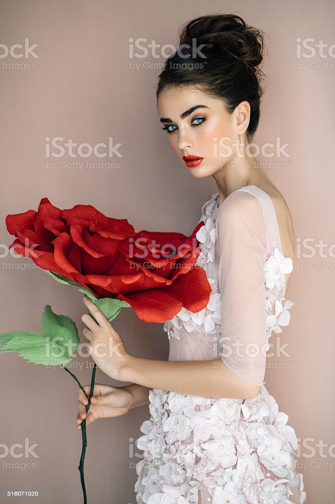 Studio Shot Of Young Beautiful Bride With Big Rose Stock Photo