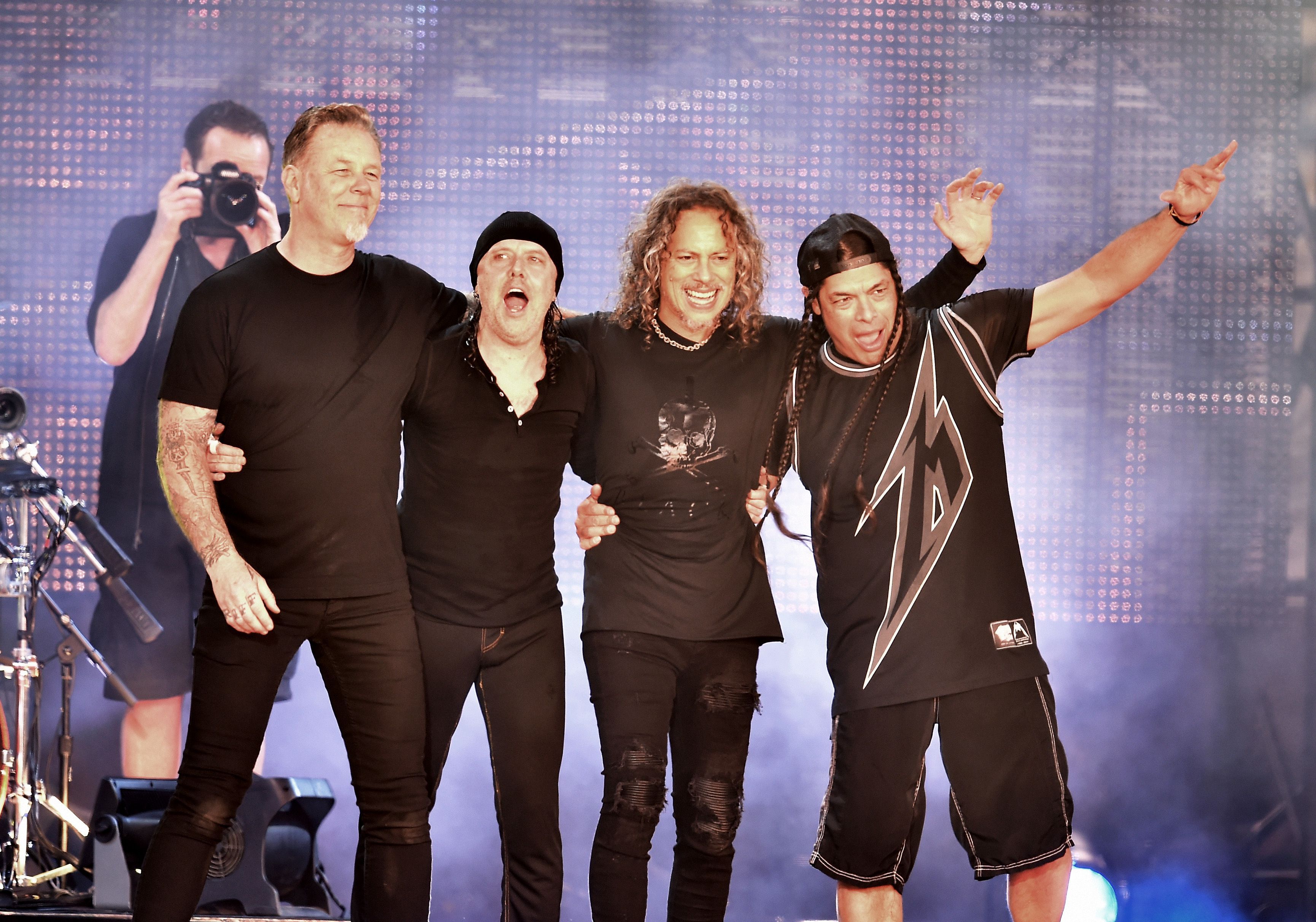 Metallica band members posing for a photo on stage