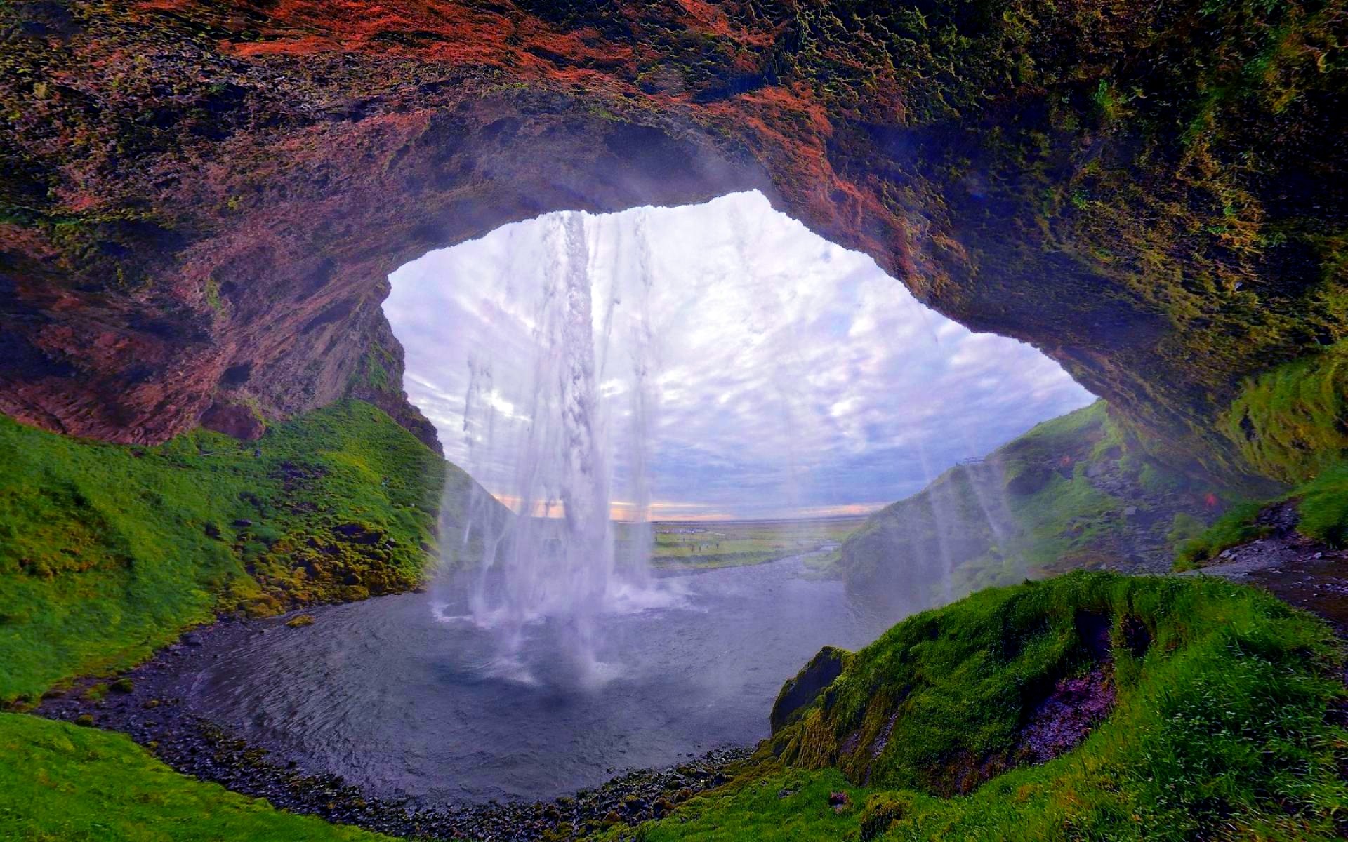 A breathtaking view of Seljalandsfoss waterfall from inside a cave in Iceland