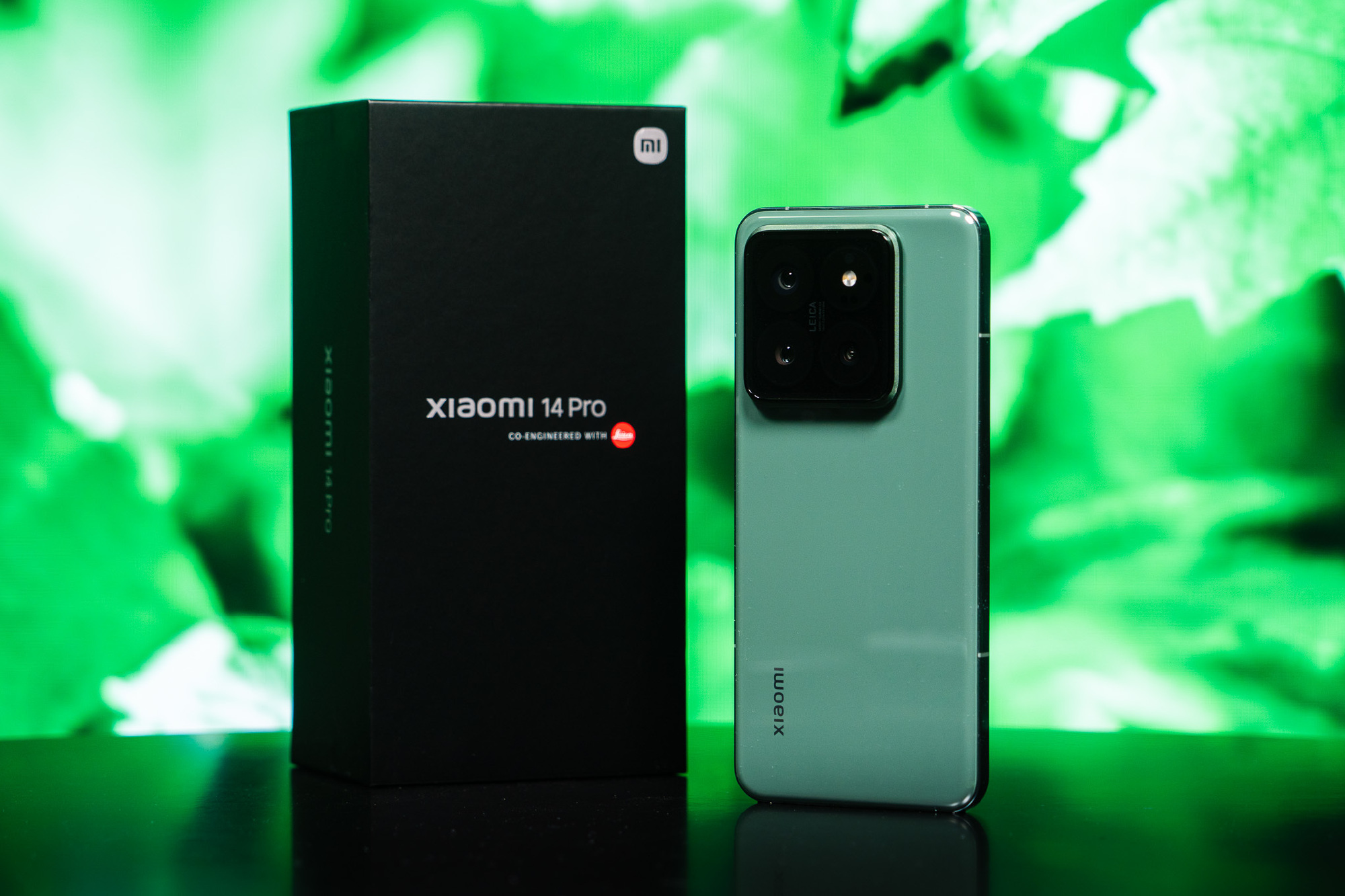 Xiaomi 14 Pro smartphone alongside its retail box, showcasing its sleek design and Leica co-engineered camera