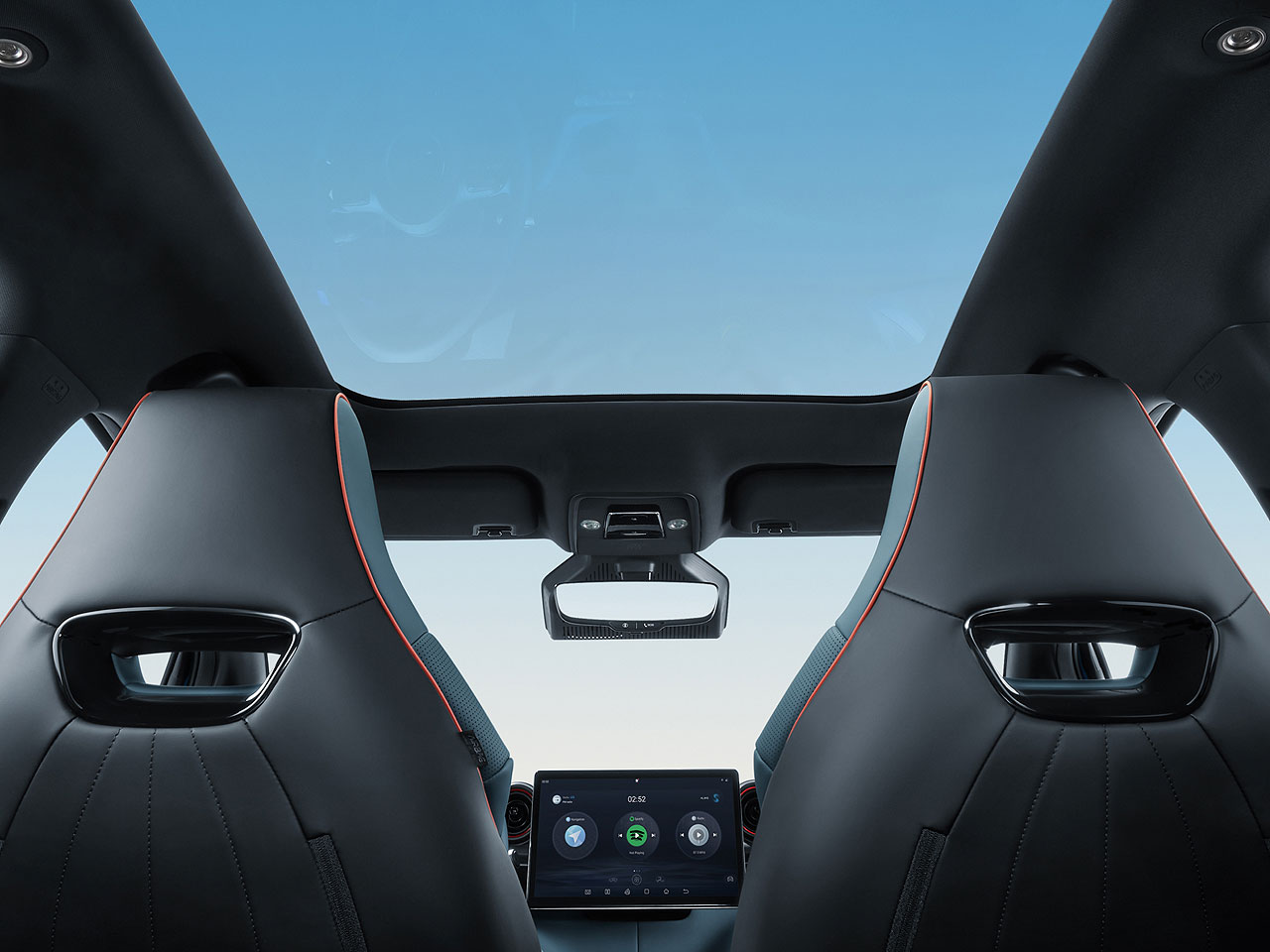 Interior view of a BYD Shark EV, showcasing the panoramic sunroof, black leather sport seats with red accents, and the central infotainment screen