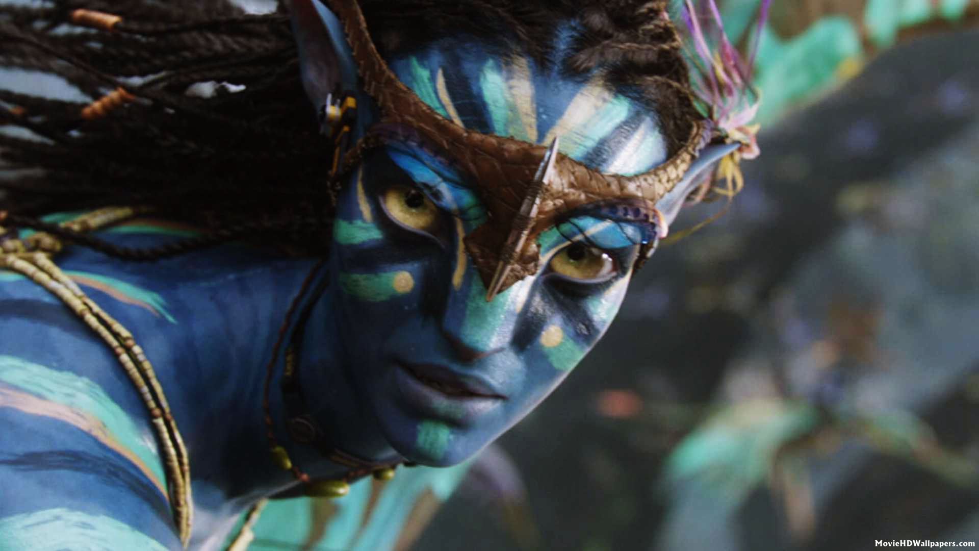 Neytiri from Avatar, a Na'vi princess, stares intensely with her yellow eyes and blue skin