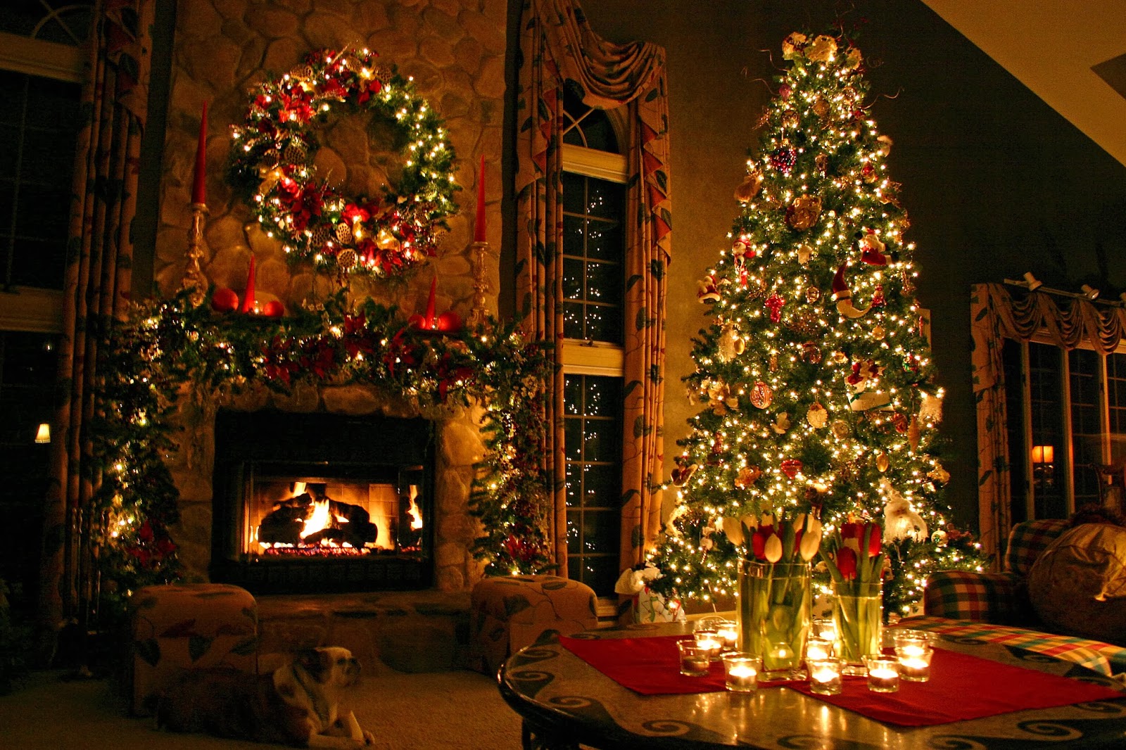 A beautifully decorated Christmas tree stands tall in a cozy living room, with a fireplace ablaze in the background, creating a warm and festive atmosphere