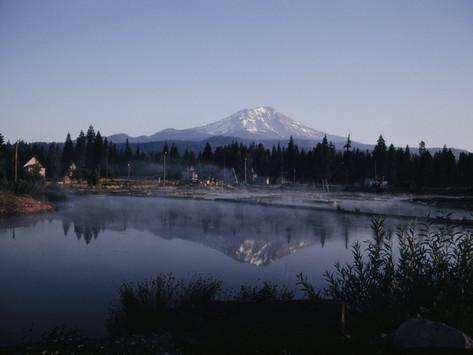A Lumber Mill With Mount Shasta In The Background