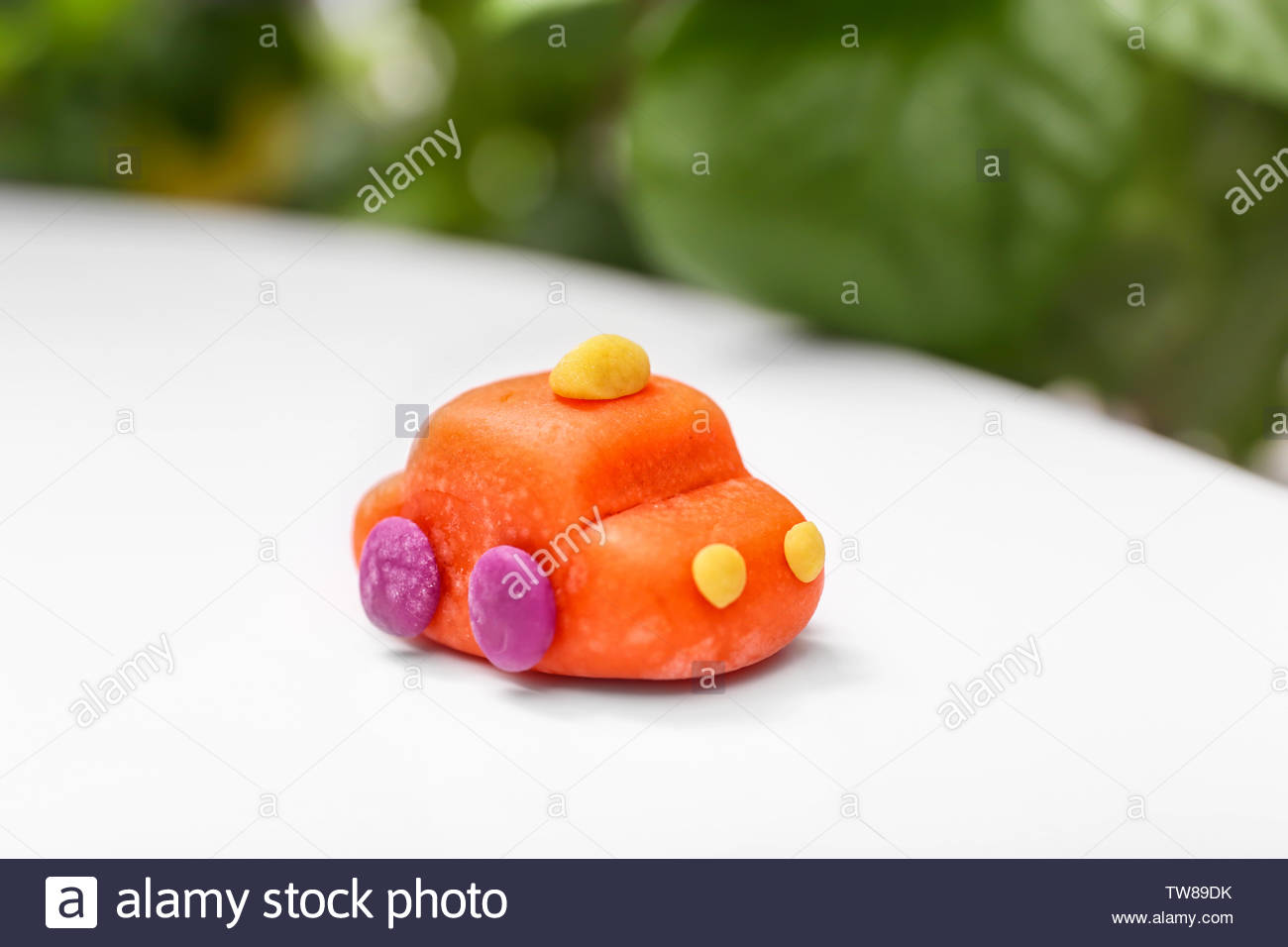 Car Made From Playdough On Table Against Blurred Background