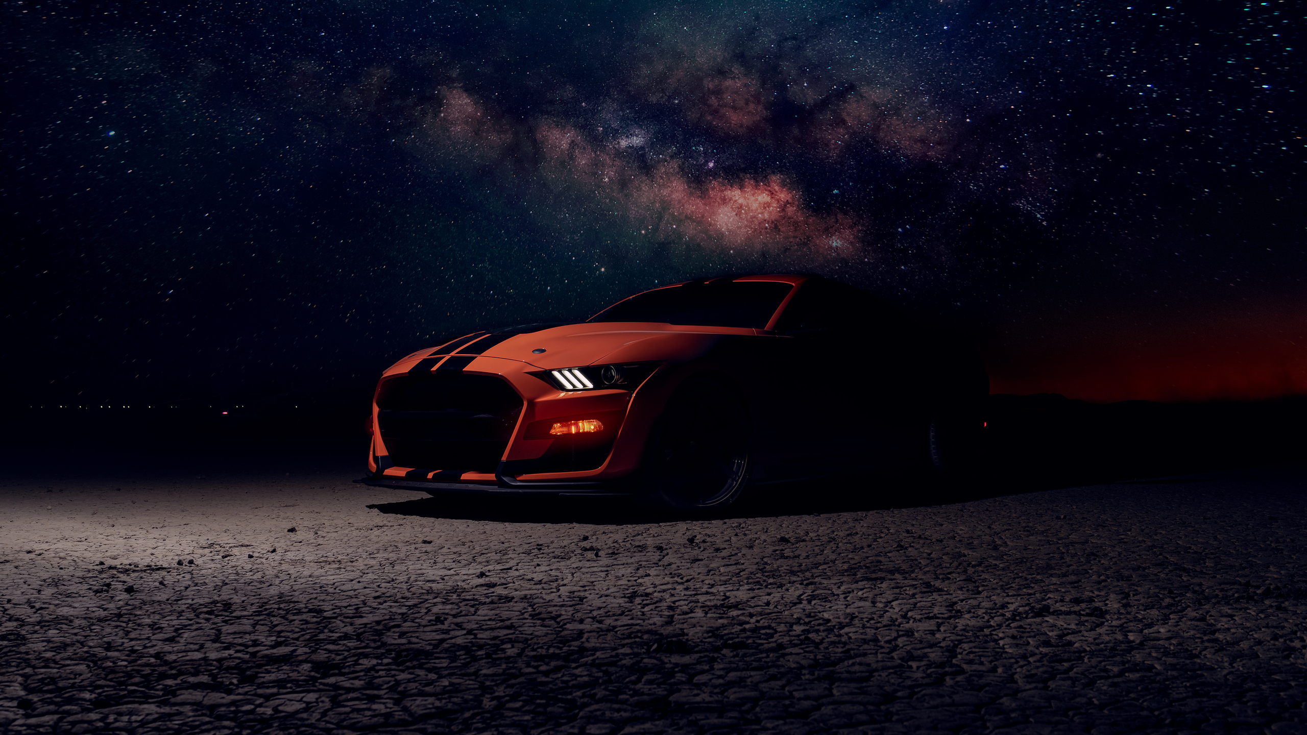 Orange Ford Mustang Shelby GT500 parked under the Milky Way