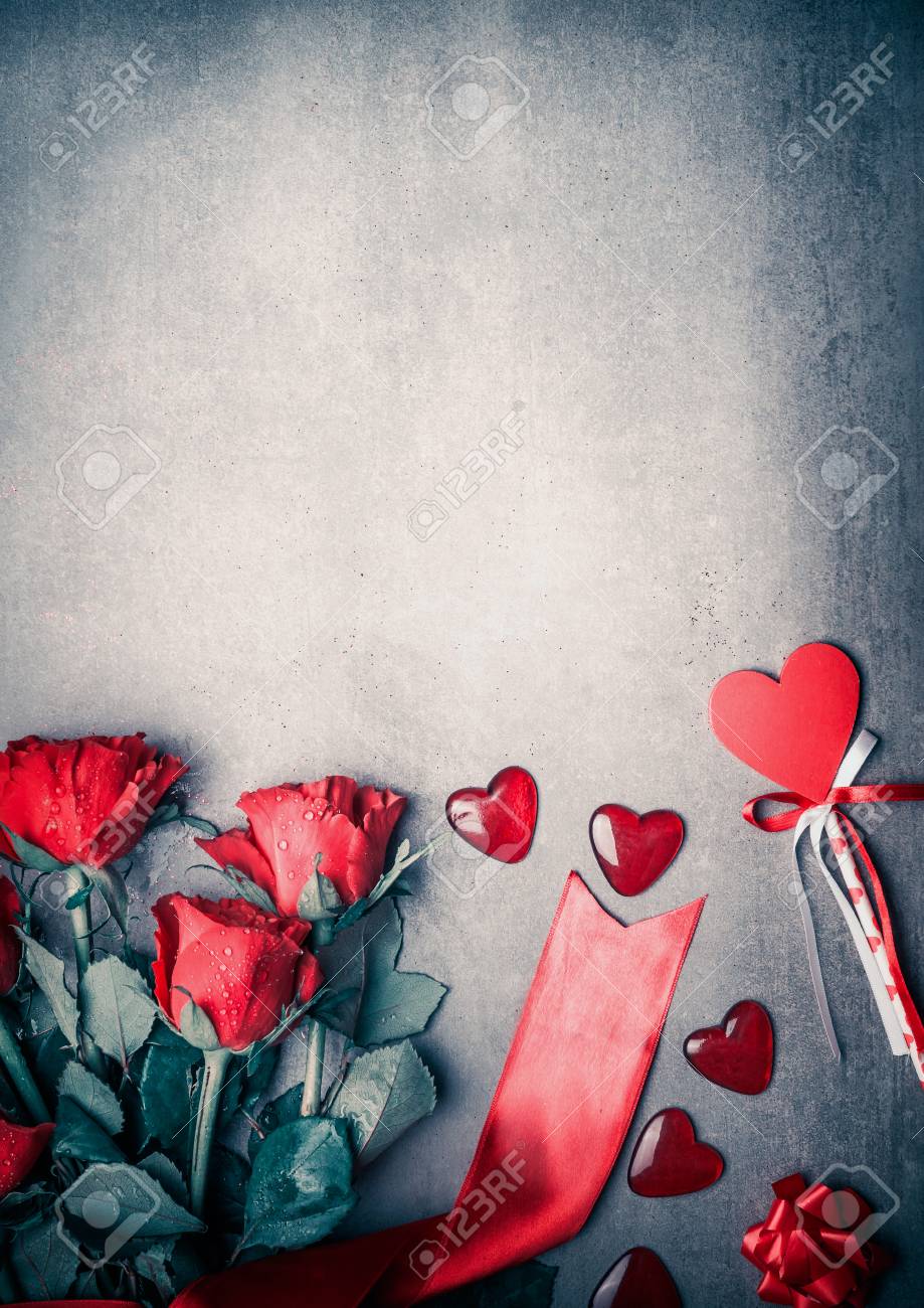 Red Roses With Ribbon And Hearts On Gray Desktop Background