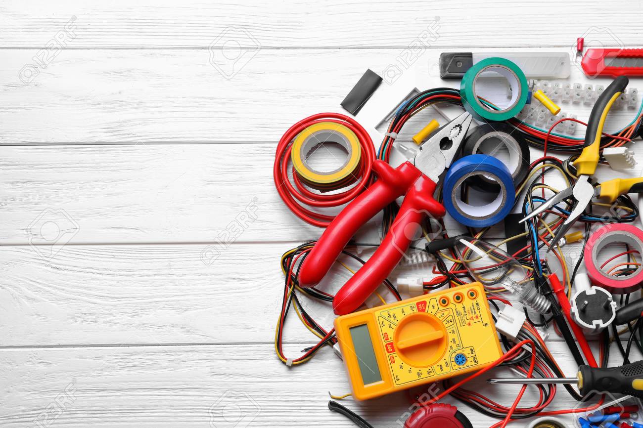 Different Electrical Tools On Wooden Background Stock Photo