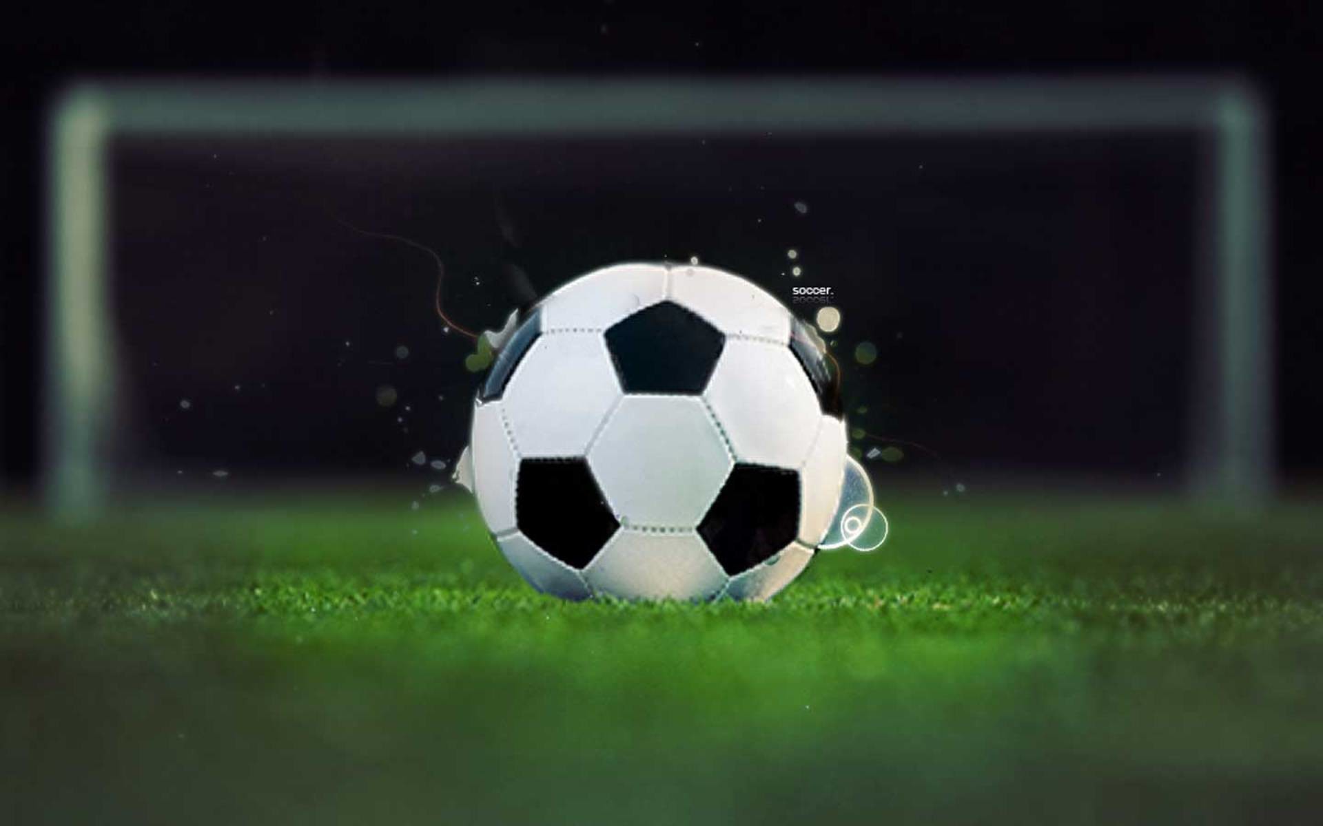 A dynamic close-up of a classic soccer ball on a vibrant green field, positioned just in front of the goal, ready for action