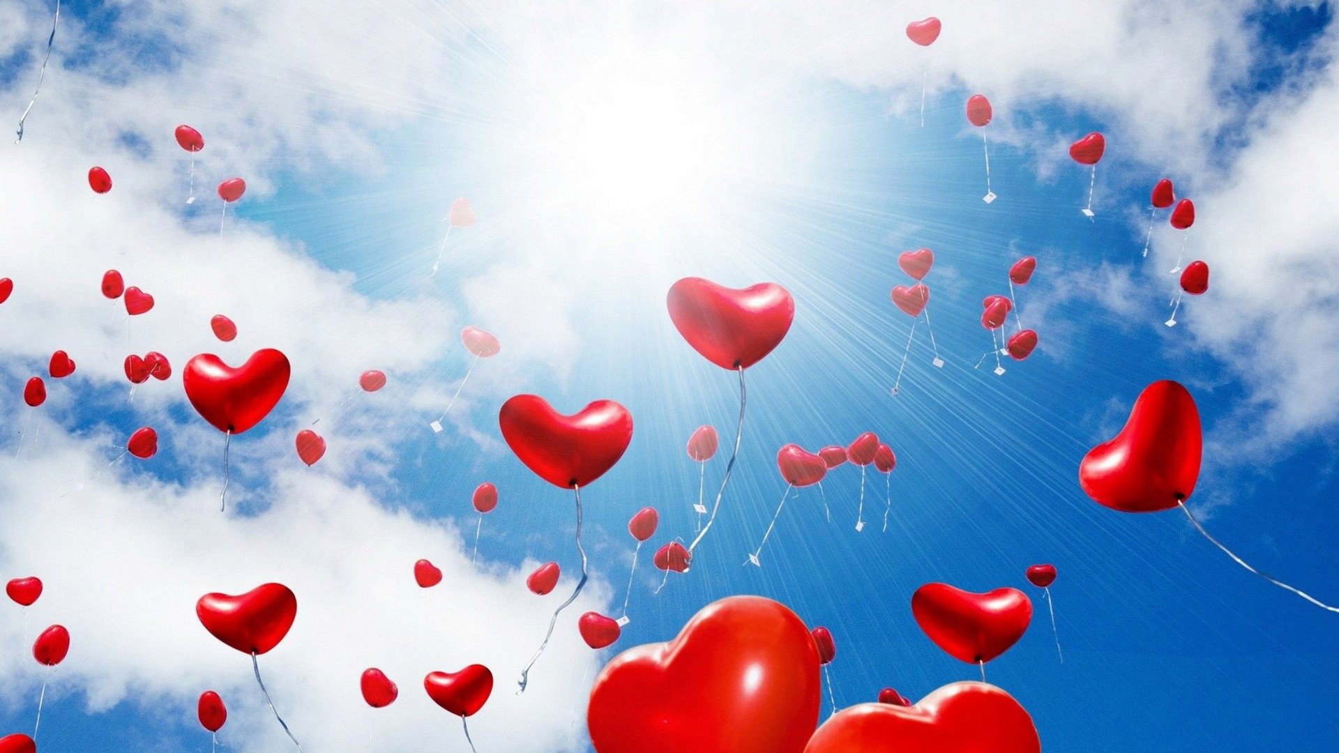 Red Balloons In The Shape Of A Heart Sunlight Blue Sky